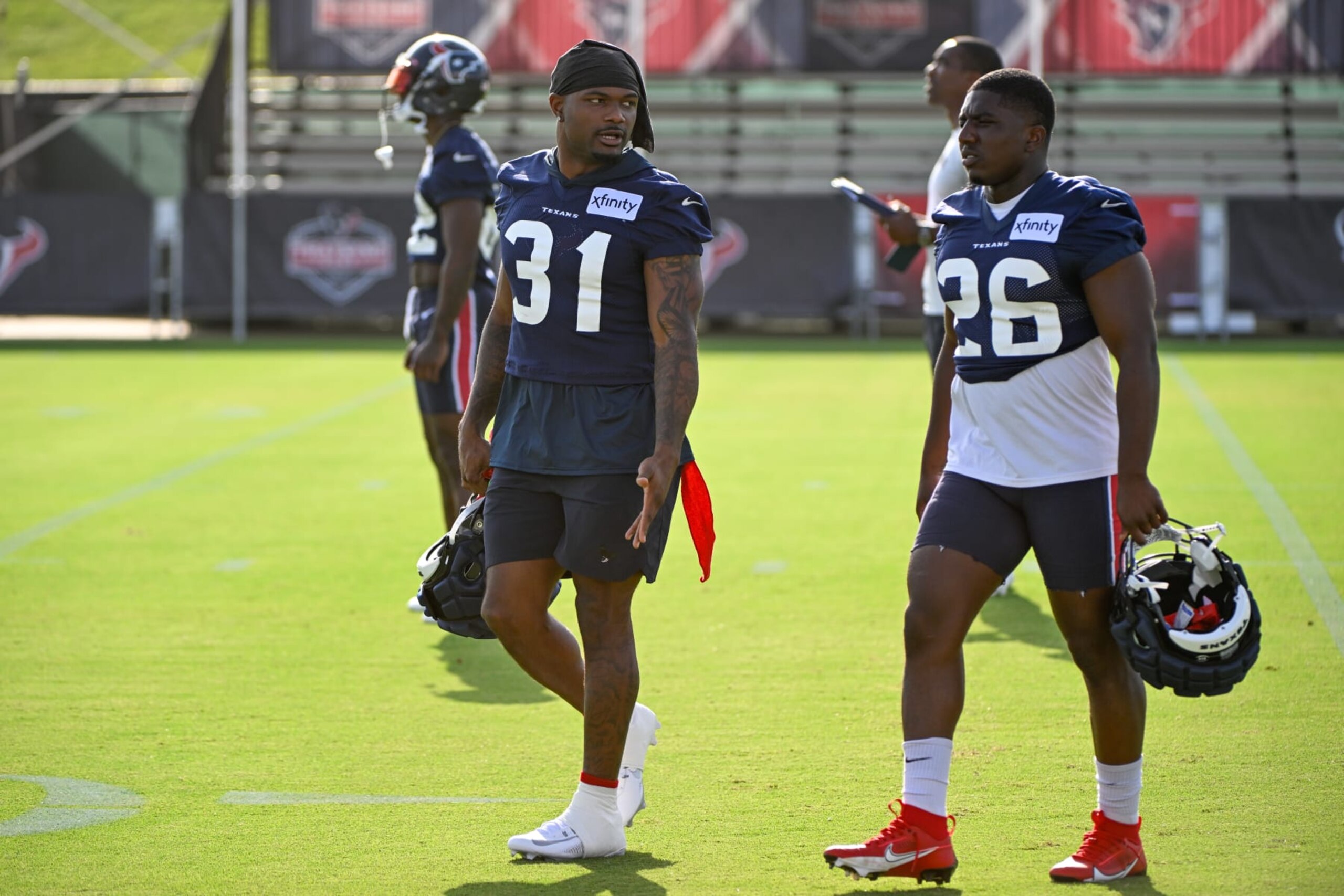HOUSTON, TX - JULY 26: Houston Texans running back Dameon Pierce (31) and Houston Texans running back Devin Singletary (26) make their way across the field during day 1 of the Texans Training Camp at Houston Methodist Training Center on July 26, 2023, in Houston, Texas. (Photo by Ken Murray/Icon Sportswire via Getty Images)