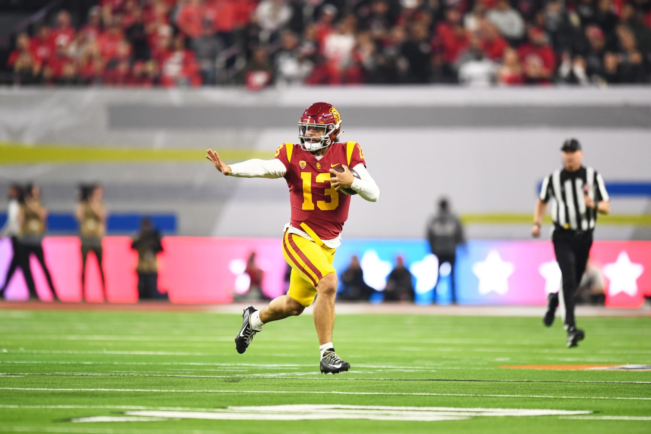 LAS VEGAS, NV - DECEMBER 02: USC Trojans quarterback Caleb Williams (13) runs up field, looking like he was making a Heisman pose, during the Pac-12 Conference championship game between the Utah Utes and the USC Trojans at Allegiant Stadium on December 2, 2022 in Las Vegas, Nevada. (Photo by Brian Rothmuller/Icon Sportswire via Getty Images)