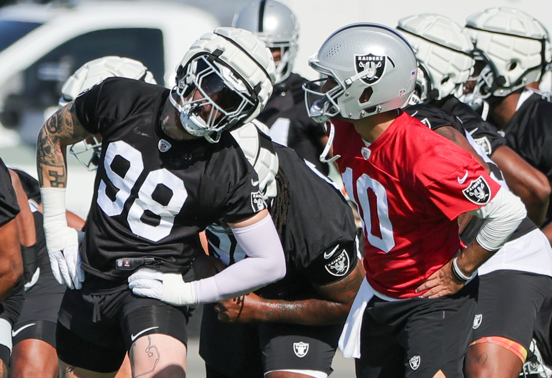 HENDERSON, NEVADA - JULY 26: Defensive end Maxx Crosby #98 and quarterback Jimmy Garoppolo #10 of the Las Vegas Raiders stretch during the first practice of the team's training camp at the Las Vegas Raiders Headquarters/Intermountain Healthcare Performance Center on July 26, 2023 in Henderson, Nevada. (Photo by Ethan Miller/Getty Images)