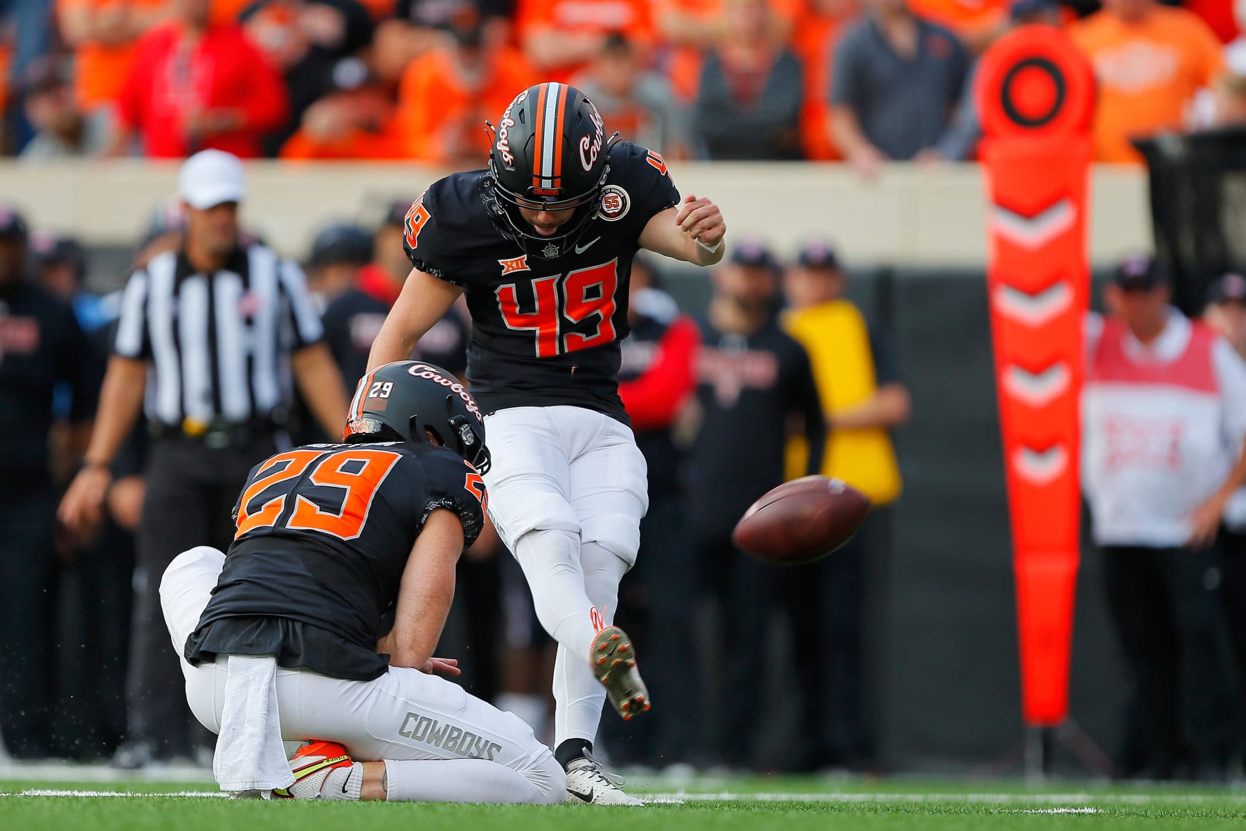 STILLWATER, OK - OCTOBER 8:  Kicker Tanner Brown #49 of the Oklahoma State Cowboys kicks the go-ahead field goal against the Texas Tech Red Raiders at the end of the third quarter at Boone Pickens Stadium on October 8, 2022 in Stillwater, Oklahoma.  Oklahoma State won 41-31.  (Photo by Brian Bahr/Getty Images)