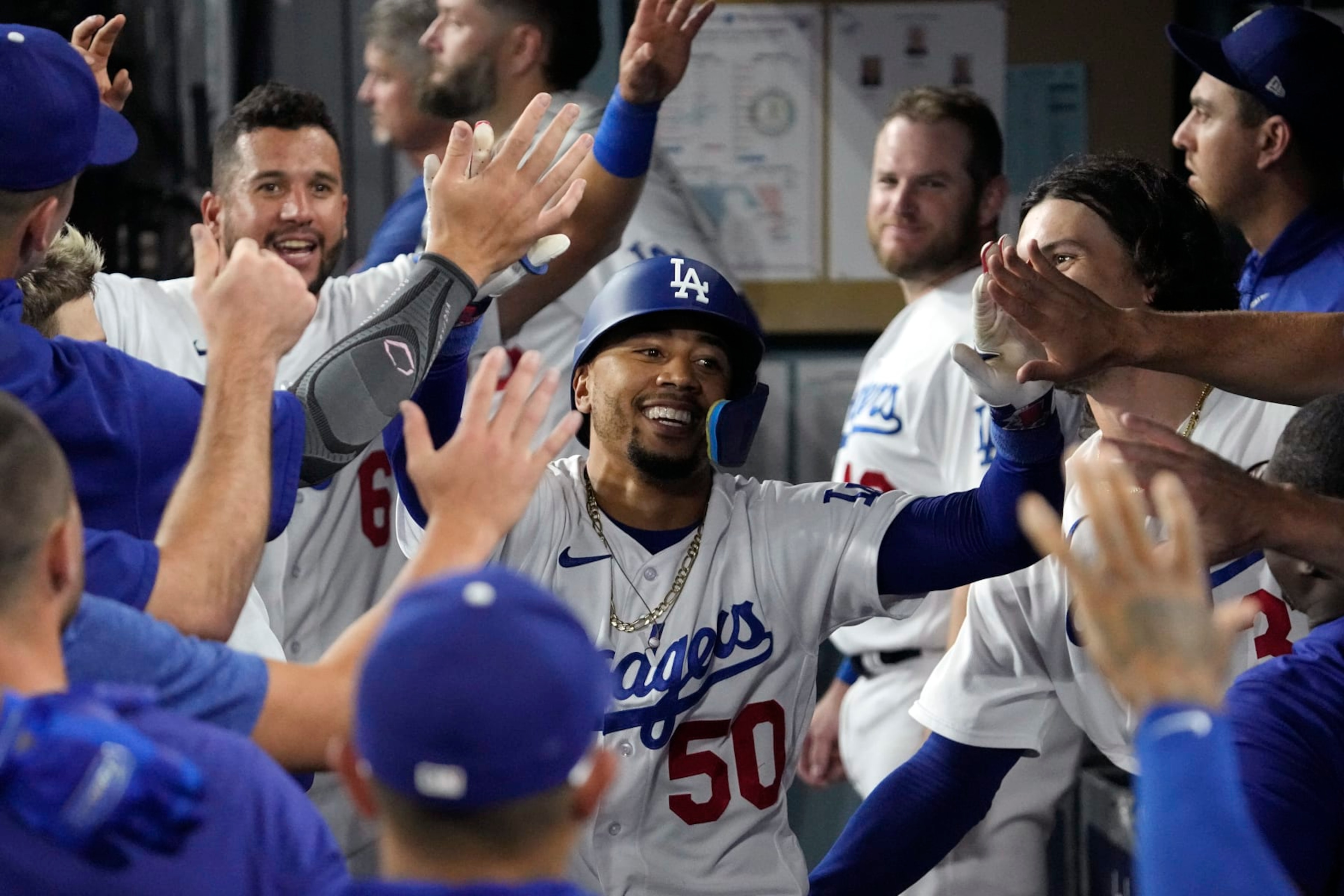 Los Angeles Dodgers' Mookie Betts is congratulated by teammates in the dugout after hitting a solo home run during the seventh inning of a baseball game against the Oakland Athletics Tuesday, Aug. 1, 2023, in Los Angeles. (AP Photo/Mark J. Terrill) Los Angeles Dodgers' Mookie Betts is congratulated by teammates in the dugout after hitting a solo home run during the seventh inning of a baseball game against the Oakland Athletics Tuesday, Aug. 1, 2023, in Los Angeles. (AP Photo/Mark J. Terrill)