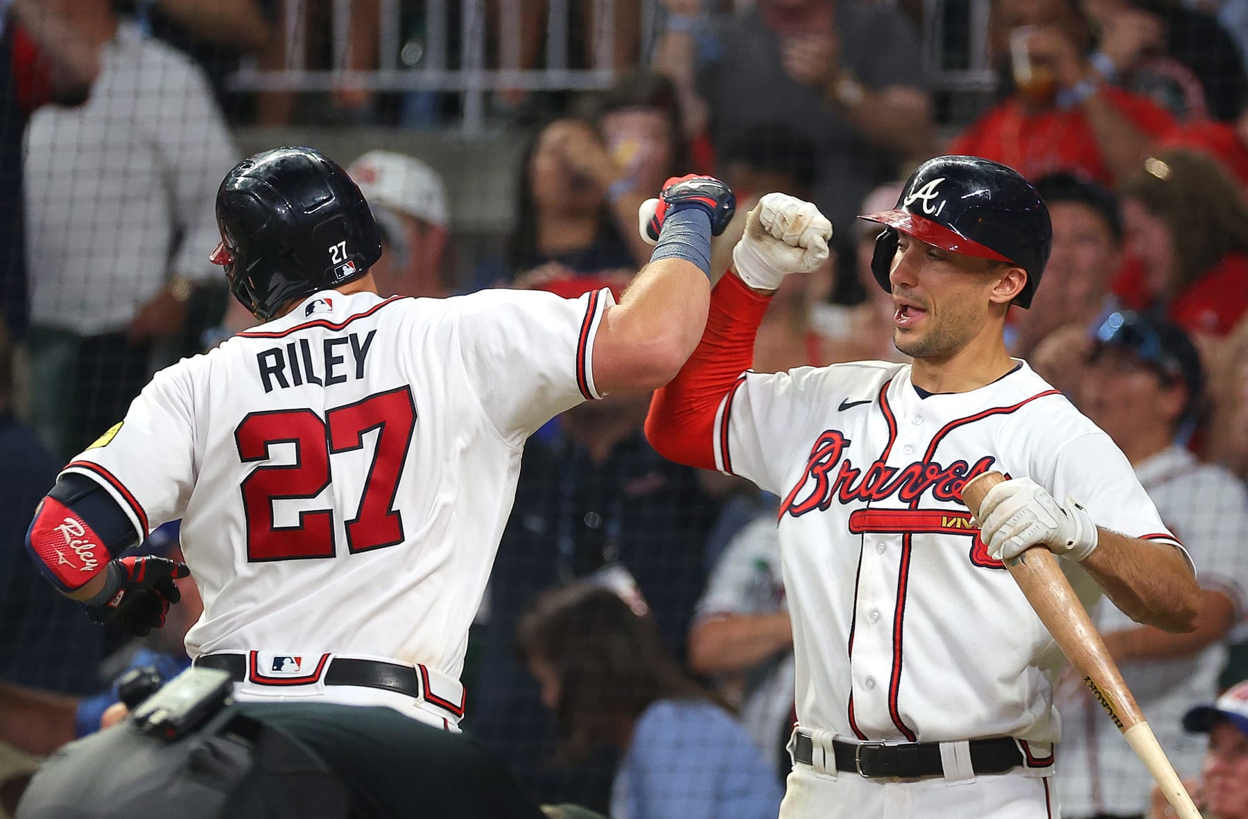 ATLANTA, GEORGIA - JULY 18:  Austin Riley #27 of the Atlanta Braves reacts with Matt Olson #28 after hitting a two-run homer in the sixth inning against the Arizona Diamondbacks at Truist Park on July 18, 2023 in Atlanta, Georgia. (Photo by Kevin C. Cox/Getty Images)