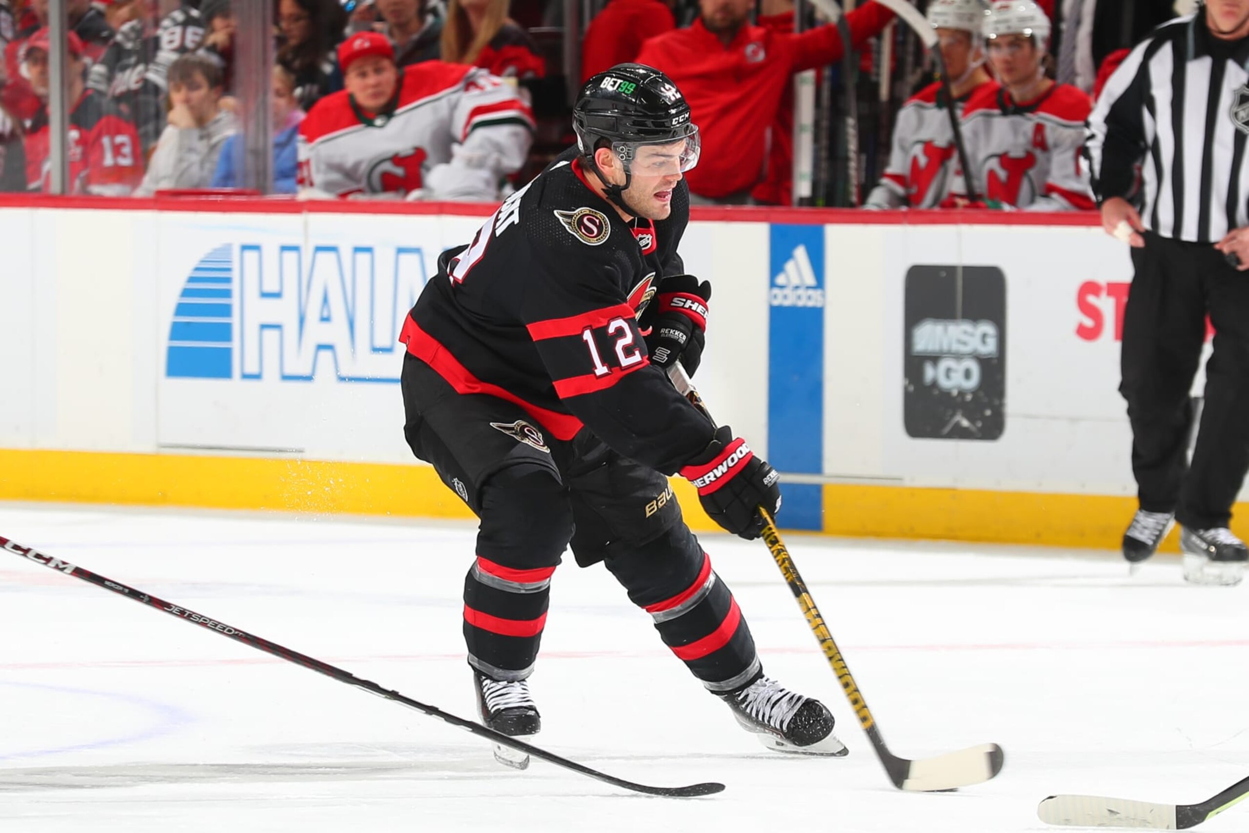 NEWARK, NJ - MARCH 25: Alex DeBrincat #12 of the Ottawa Senators skates in the second period of the game against the New Jersey Devils at the Prudential Center on March 25, 2023 in Newark, New Jersey.  (Photo by Rich Graessle/NHLI via Getty Images)