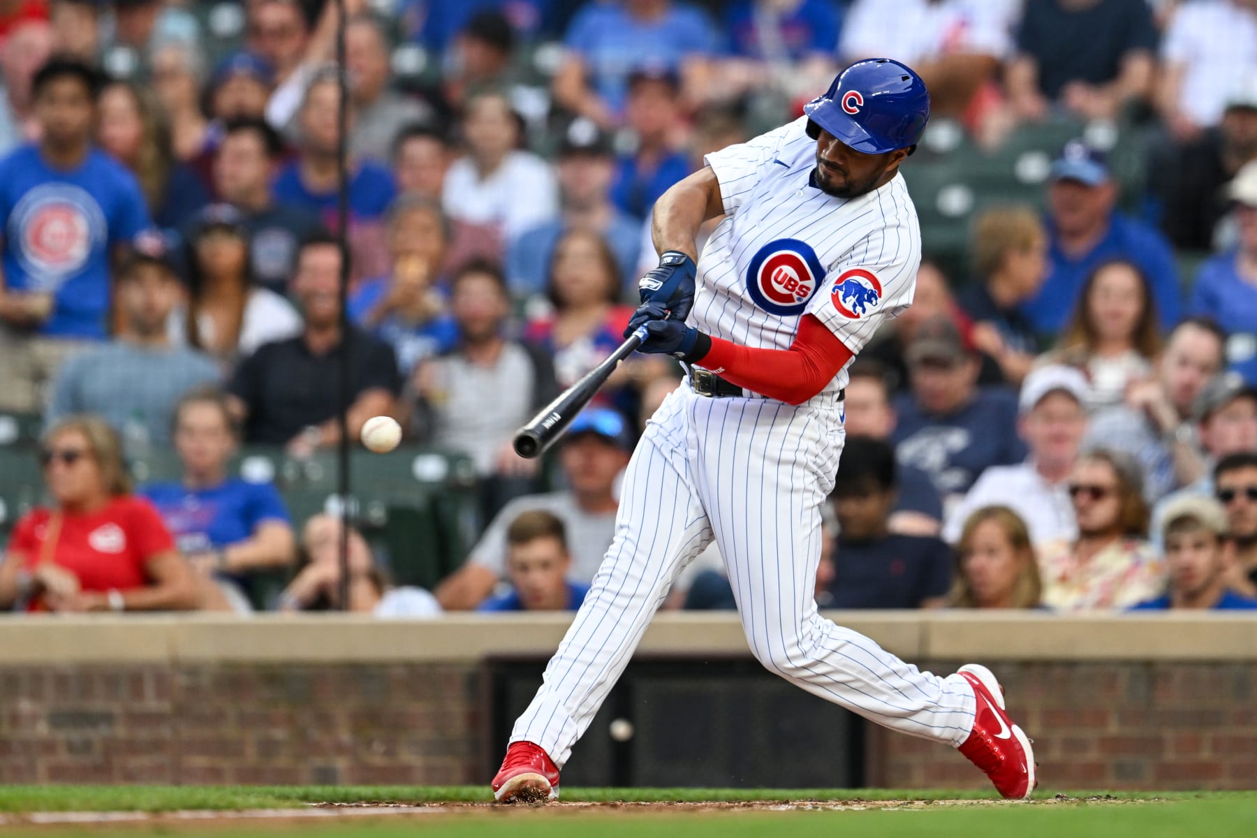 CHICAGO, ILLINOIS - AUGUST 01: Jeimer Candelario #9 of the Chicago Cubs hits a single in the first inning against Ben Lively of the Cincinnati Reds at Wrigley Field on August 01, 2023 in Chicago, Illinois. (Photo by Quinn Harris/Getty Images)
