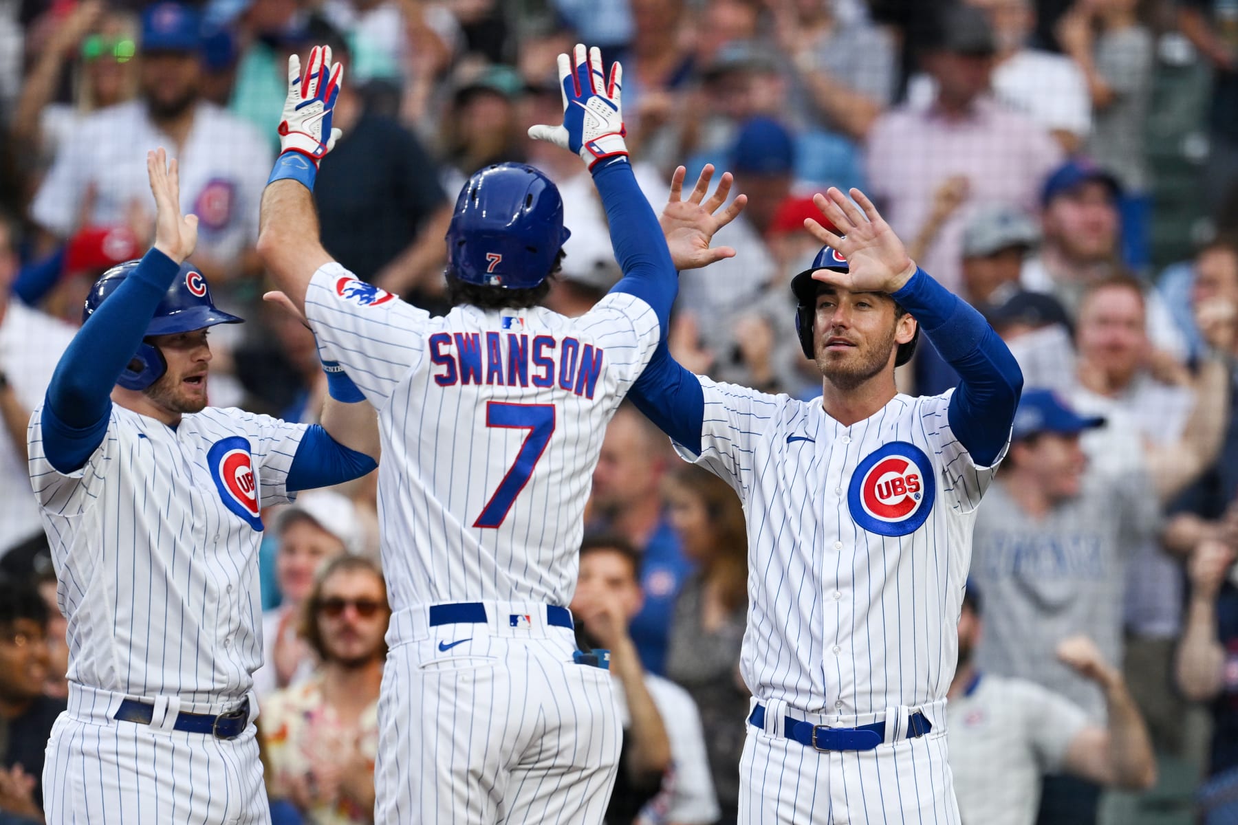 CHICAGO, ILLINOIS - AUGUST 01: Ian Happ #8 and Cody Bellinger #24 celebrates after Dansby Swanson #7 of the Chicago Cubs hit a two-run home run in the first inning against Ben Lively of the Cincinnati Reds at Wrigley Field on August 01, 2023 in Chicago, Illinois. (Photo by Quinn Harris/Getty Images)