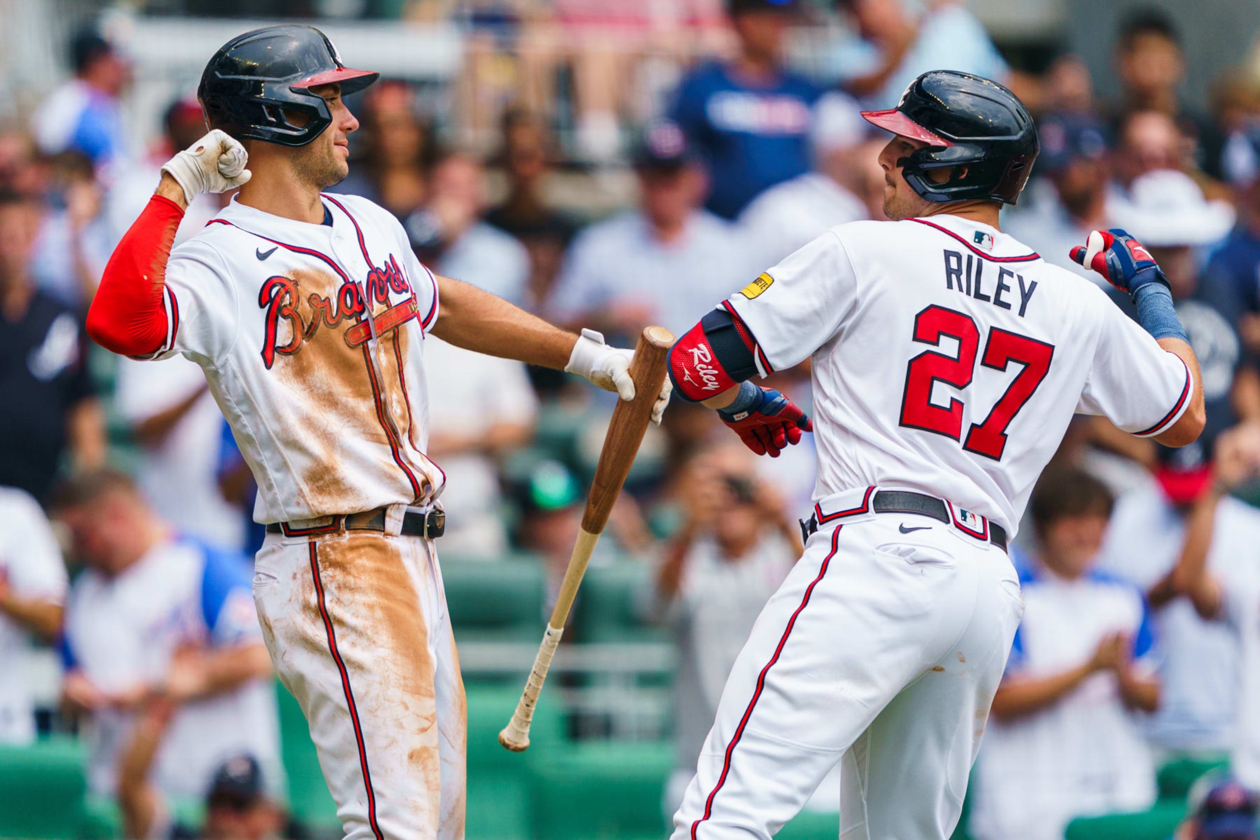 ATLANTA, GA - AUGUST 2: Austin Riley #27 of the Atlanta Braves celebrates with Matt Olson #28 after hitting a home run in the fourth inning during the game against the Los Angeles Angels at Truist Park on August 2, 2023 in Atlanta, Georgia. (Photo by Matthew Grimes Jr./Atlanta Braves/Getty Images)