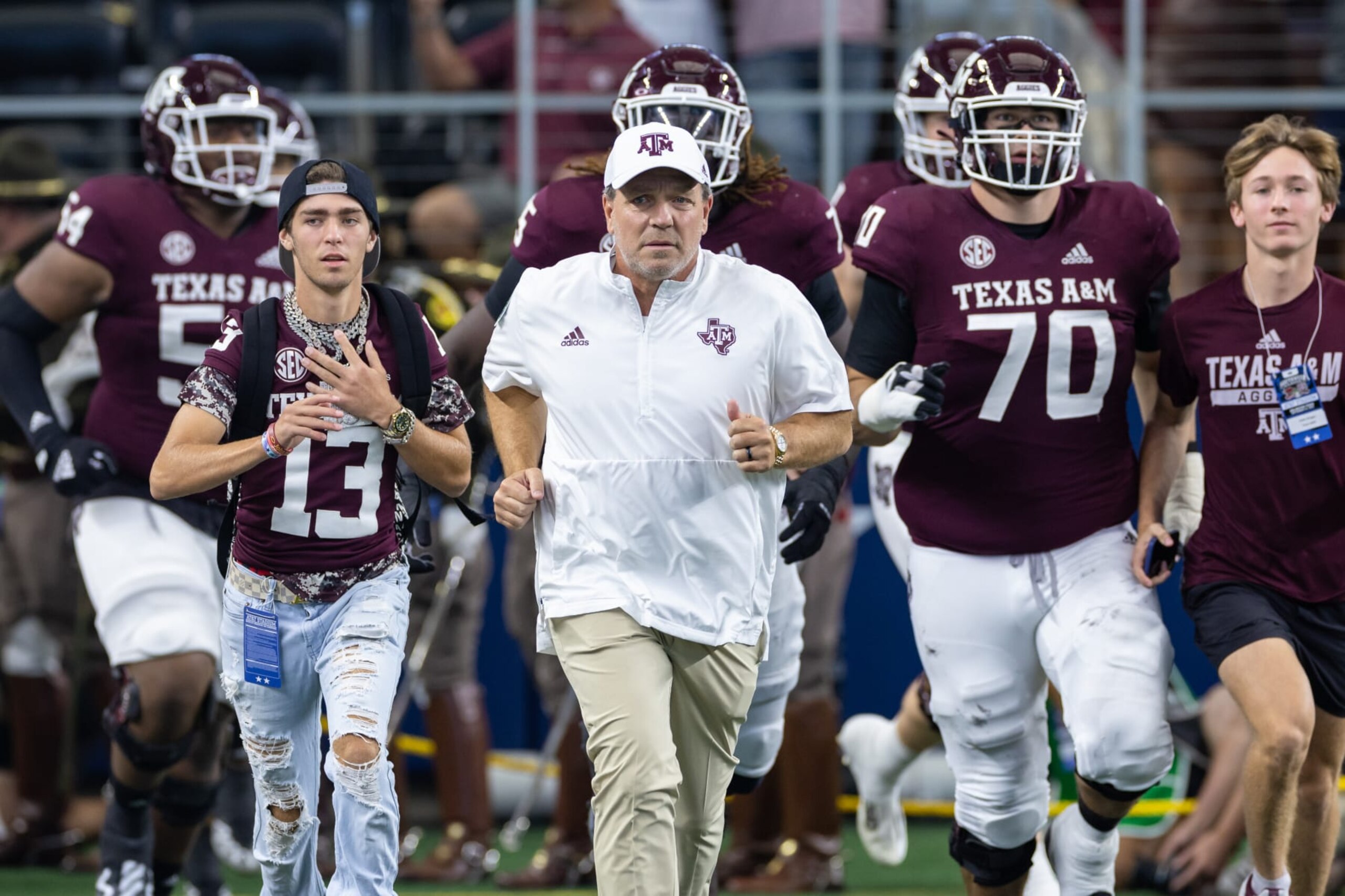 ARLINGTON, TX - SEPTEMBER 24: Texas A&M Aggies head coach Jimbo Fisher leads his team onto he field during the Southwest Classic college football game between the Texas A&M Aggies and the Arkansas Razorbacks on September 24, 2022 at AT&T Stadium in Arlington, TX. (Photo by Matthew Visinsky/Icon Sportswire via Getty Images) ARLINGTON, TX - SEPTEMBER 24: Texas A&M Aggies head coach Jimbo Fisher leads his team onto he field during the Southwest Classic college football game between the Texas A&M Aggies and the Arkansas Razorbacks on September 24, 2022 at AT&T Stadium in Arlington, TX. (Photo by Matthew Visinsky/Icon Sportswire via Getty Images)