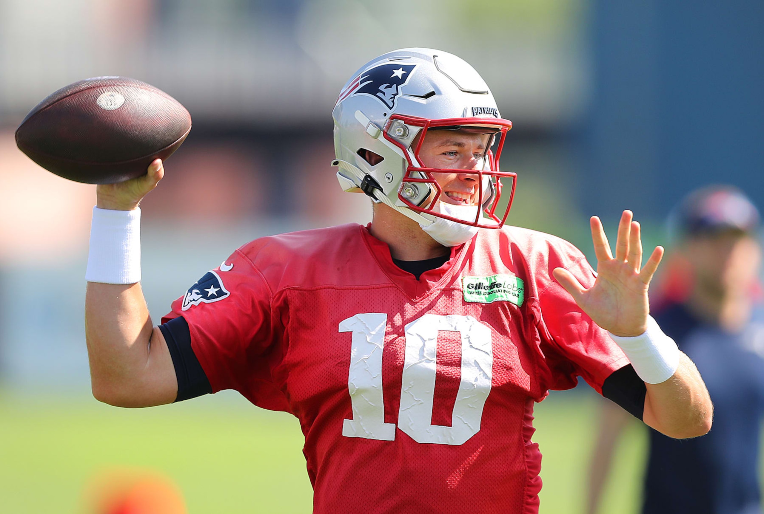 Foxborough, MA - July 28: New England Patriots QB Mac Jones smiles as he throws a pass. (Photo by John Tlumacki/The Boston Globe via Getty Images)