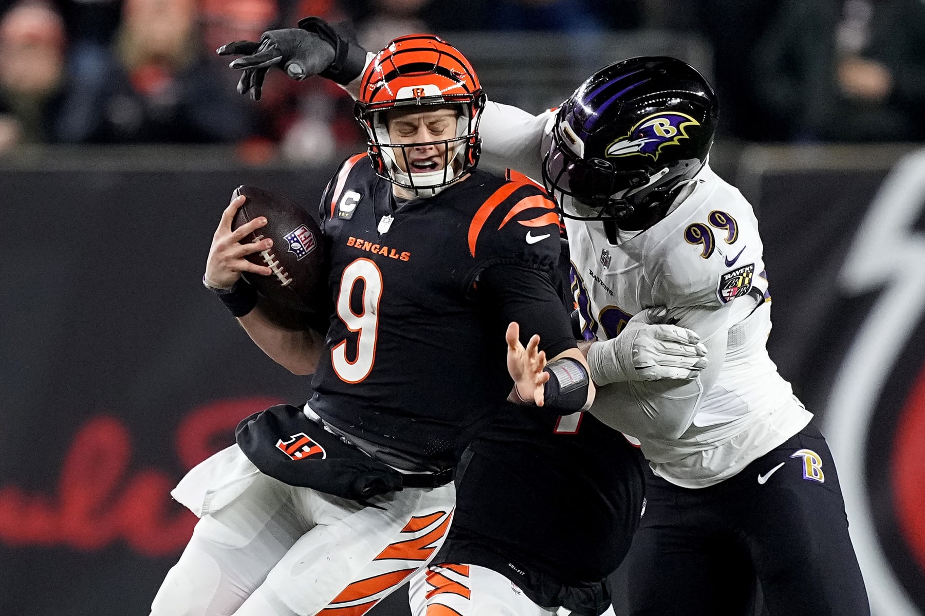 CINCINNATI, OHIO - JANUARY 15: Odafe Oweh #99 of the Baltimore Ravens sacks Joe Burrow #9 of the Cincinnati Bengals during the second quarter in the AFC Wild Card playoff game at Paycor Stadium on January 15, 2023 in Cincinnati, Ohio. (Photo by Dylan Buell/Getty Images)
