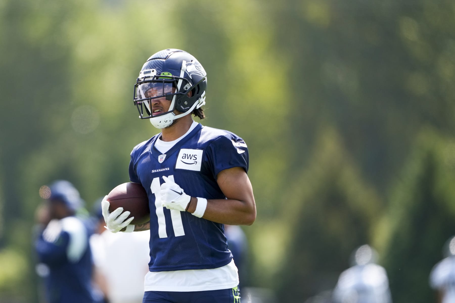 Seattle Seahawks wide receiver Jaxon Smith-Njigba (11) runs the ball during a "Back Together Weekend" event at the NFL football team's training facility, Sunday, July 30, 2023, in Renton, Wash. (AP Photo/Lindsey Wasson)