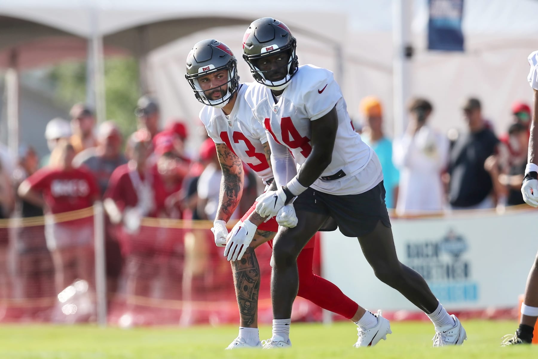 TAMPA, FL - JUL 30: Tampa Bay Buccaneers Wide Receivers Mike Evans (13) & Chris Godwin (14) go thru a drill together during the Tampa Bay Buccaneers Training Camp on July 30, 2023 at the AdventHealth Training Center at One Buccaneer Place in Tampa, Florida. (Photo by Cliff Welch/Icon Sportswire via Getty Images)