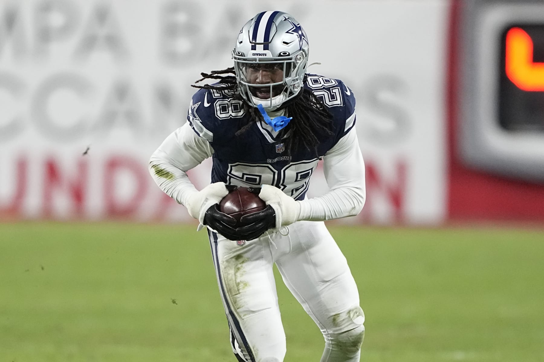Dallas Cowboys safety Malik Hooker (28) runs after picking up a fumble against the Tampa Bay Buccaneers during the second half of an NFL wild-card football game, Monday, Jan. 16, 2023, in Tampa, Fla. The fumble was over ruled on a replay. (AP Photo/Chris Carlson)