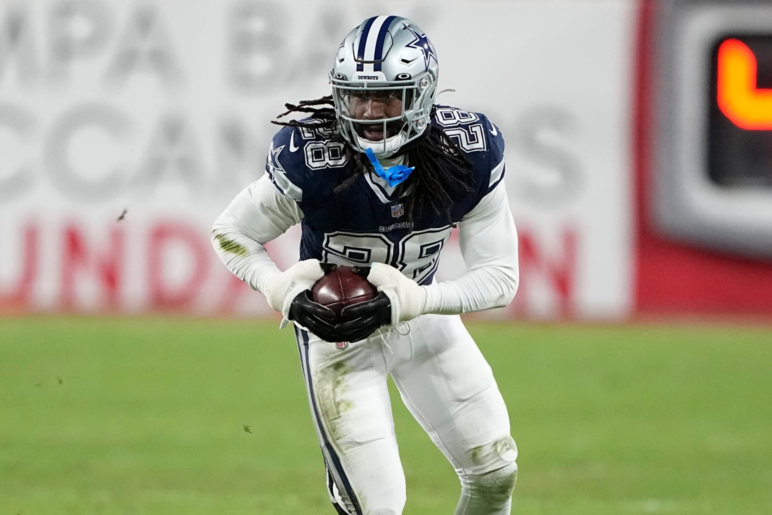 Dallas Cowboys safety Malik Hooker (28) runs after picking up a fumble against the Tampa Bay Buccaneers during the second half of an NFL wild-card football game, Monday, Jan. 16, 2023, in Tampa, Fla. The fumble was over ruled on a replay. (AP Photo/Chris Carlson)