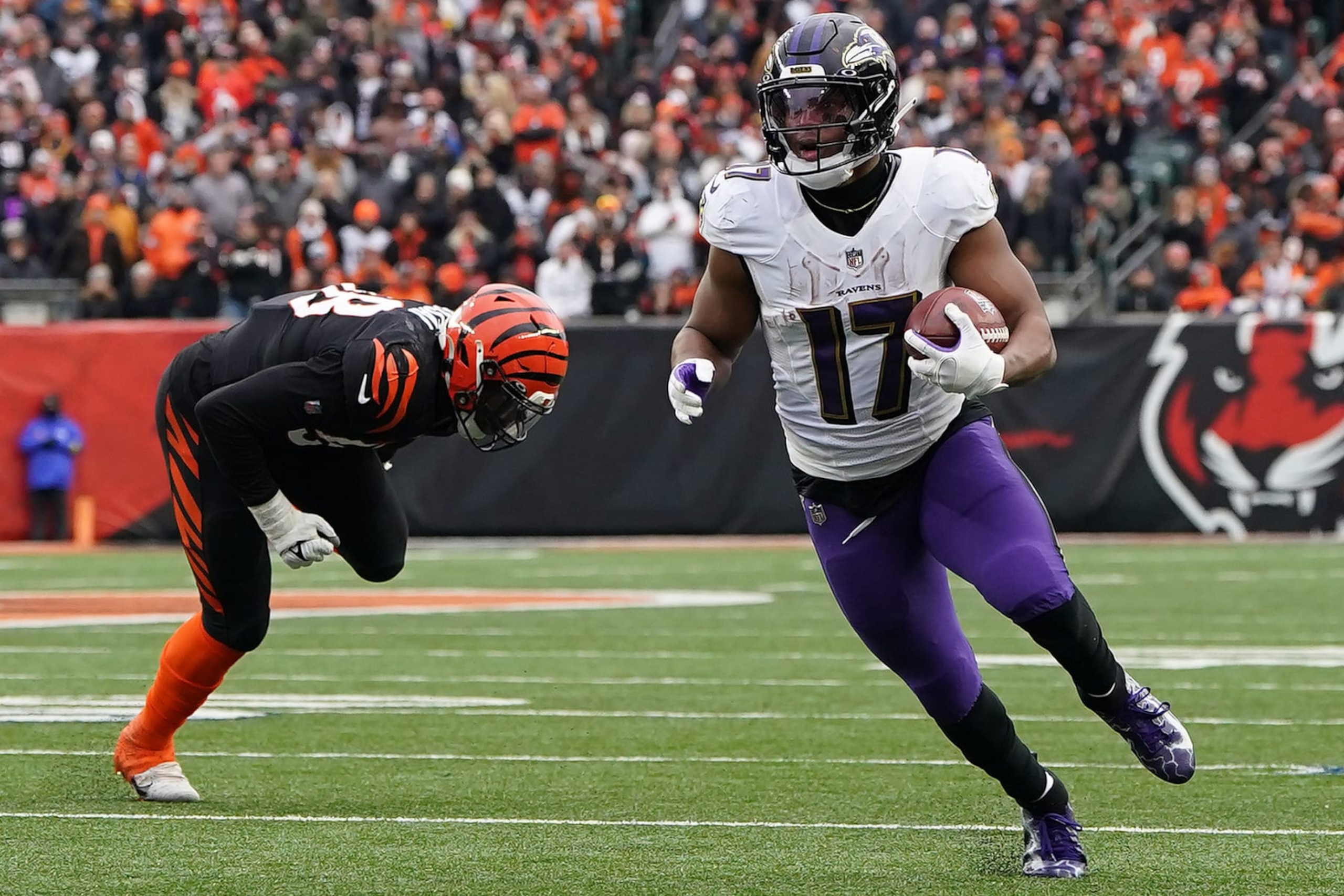 CINCINNATI, OHIO - JANUARY 08: Kenyan Drake #17 of the Baltimore Ravens runs with the ball in front of Joseph Ossai #58 of the Cincinnati Bengals during the fourth quarter at Paycor Stadium on January 08, 2023 in Cincinnati, Ohio. (Photo by Dylan Buell/Getty Images)