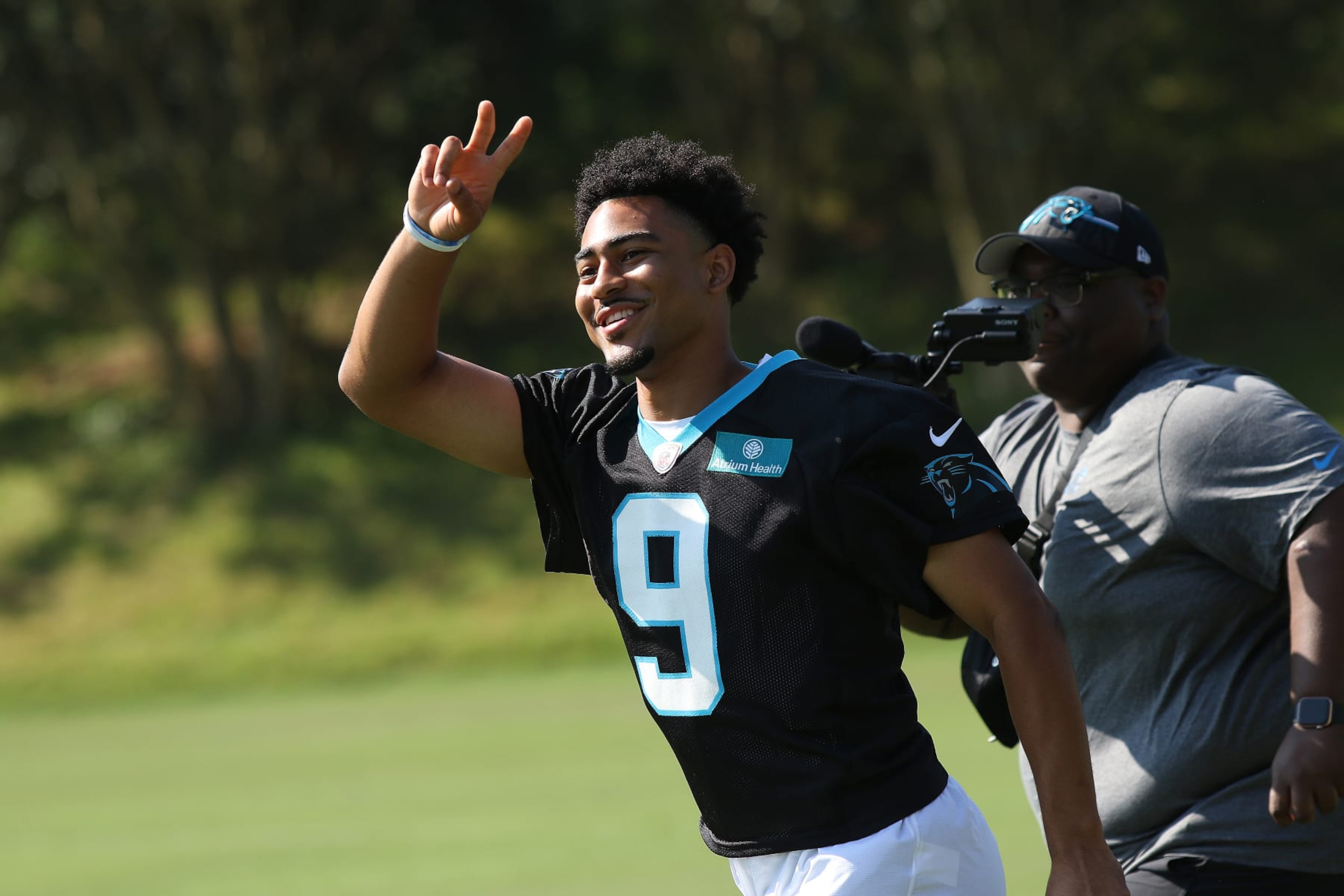 SPARTANBURG, SC - JULY 26: Carolina Panthers quarterback Bryce Young (9) waves to the fans as he runs on to the field during the NFL Carolina Panthers training camp on July 26, 2023, at Wofford College campus in Spartanburg, S.C. (Photo by John Byrum/Icon Sportswire via Getty Images) SPARTANBURG, SC - JULY 26: Carolina Panthers quarterback Bryce Young (9) waves to the fans as he runs on to the field during the NFL Carolina Panthers training camp on July 26, 2023, at Wofford College campus in Spartanburg, S.C. (Photo by John Byrum/Icon Sportswire via Getty Images)