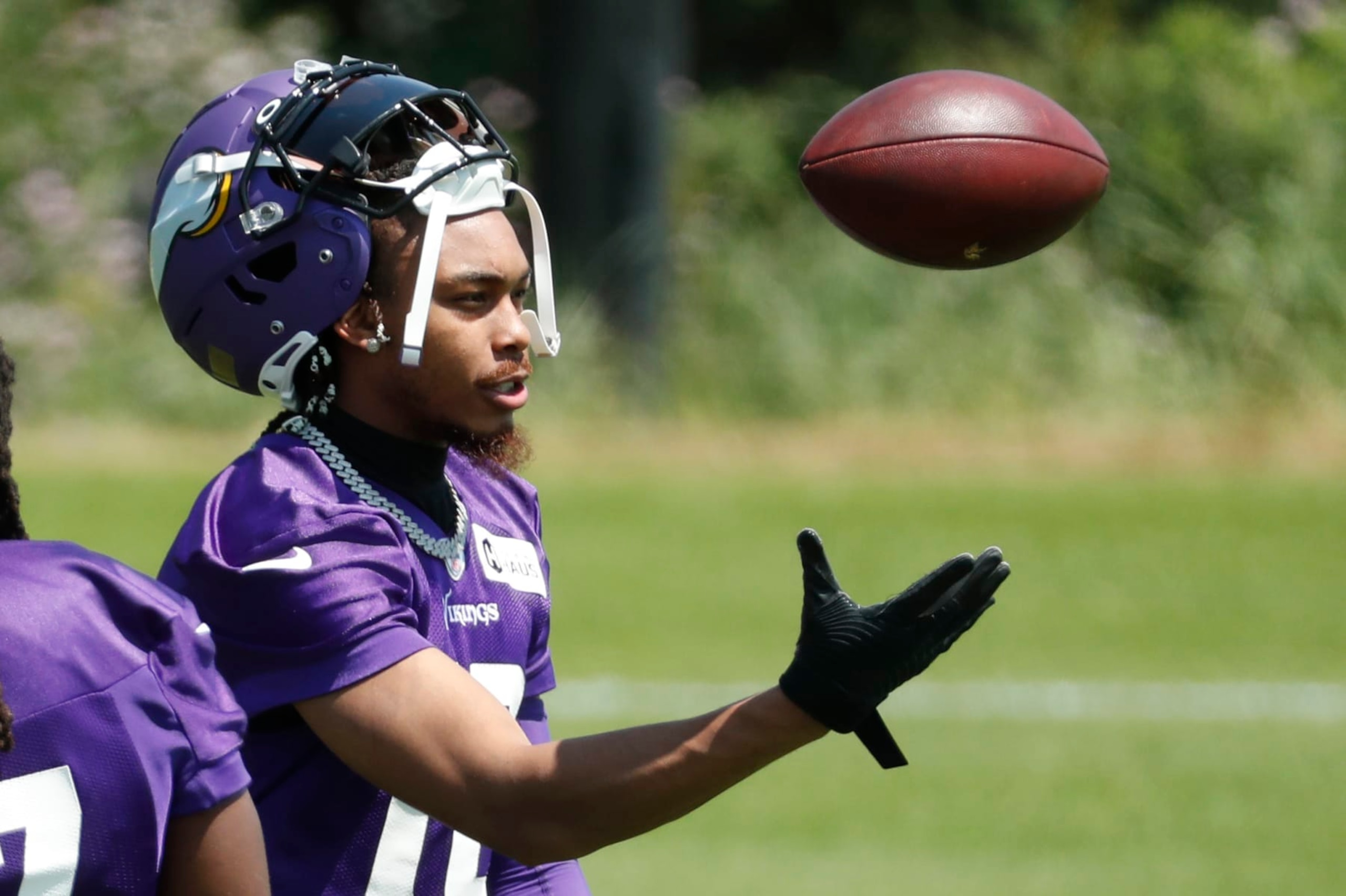 Minnesota Vikings wide receiver Justin Jefferson tosses a ball during an NFL football practice Tuesday, June 13, 2023, in Eagan, Minn.. (AP Photo/Bruce Kluckhohn)