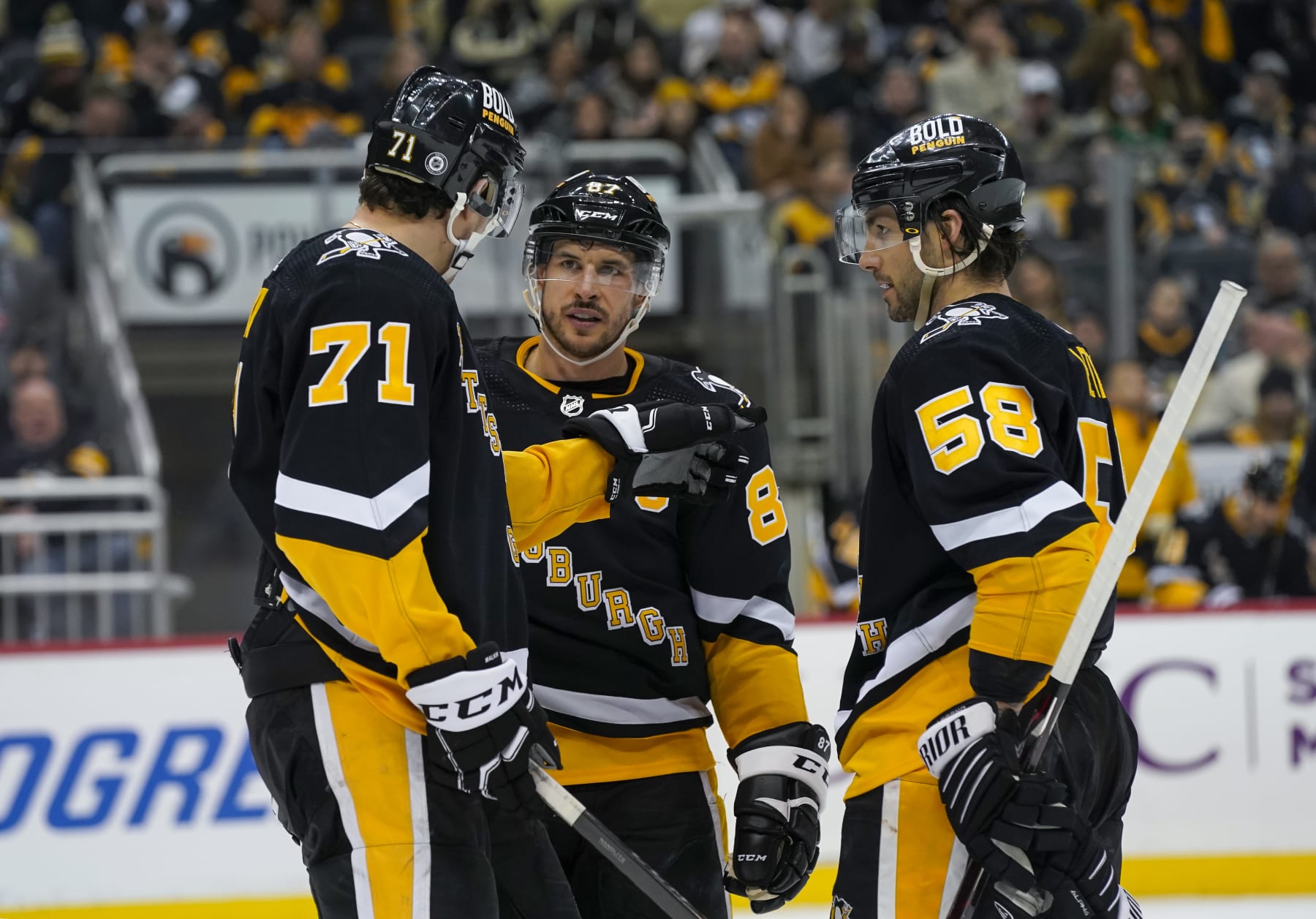 PITTSBURGH, PA - JANUARY 23: The three longest tenured members of the Pittsburgh Penguins - Center Evgeni Malkin (71), Center Sidney Crosby (87), and Defenseman Kris Letang (58) talk during the second period in the NHL game between the Pittsburgh Penguins and the Winnipeg Jets on January 23, 2022, at PPG Paints Arena in Pittsburgh, PA. (Photo by Jeanine Leech/Icon Sportswire via Getty Images)