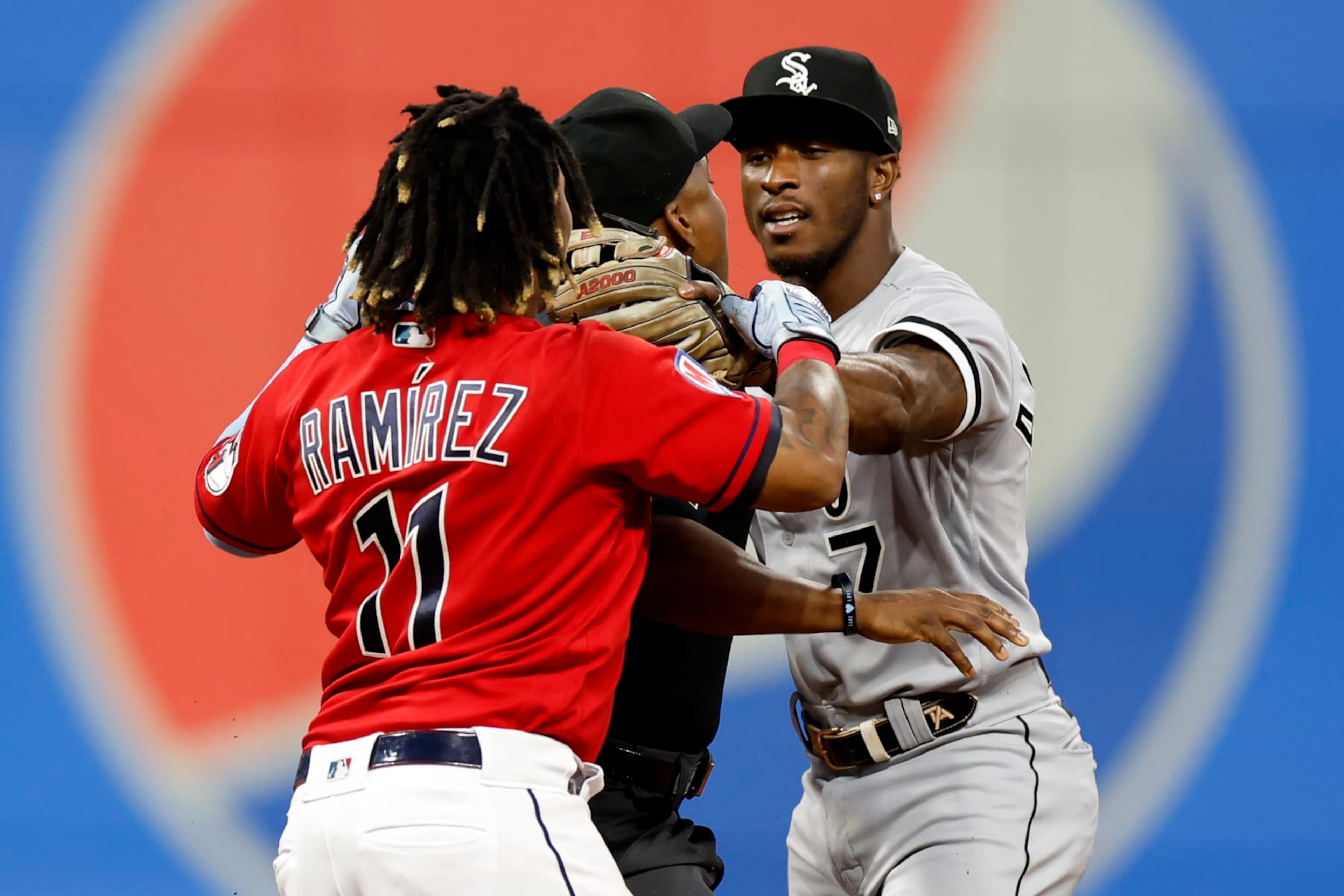 CLEVELAND, OH - AUGUST 05: Jose Ramirez #11 of the Cleveland Guardians and Tim Anderson #7 of the Chicago White Sox start to fight as umpire Malachi Moore #44 gets between them during the sixth inning at Progressive Field on August 05, 2023 in Cleveland, Ohio. (Photo by Ron Schwane/Getty Images)