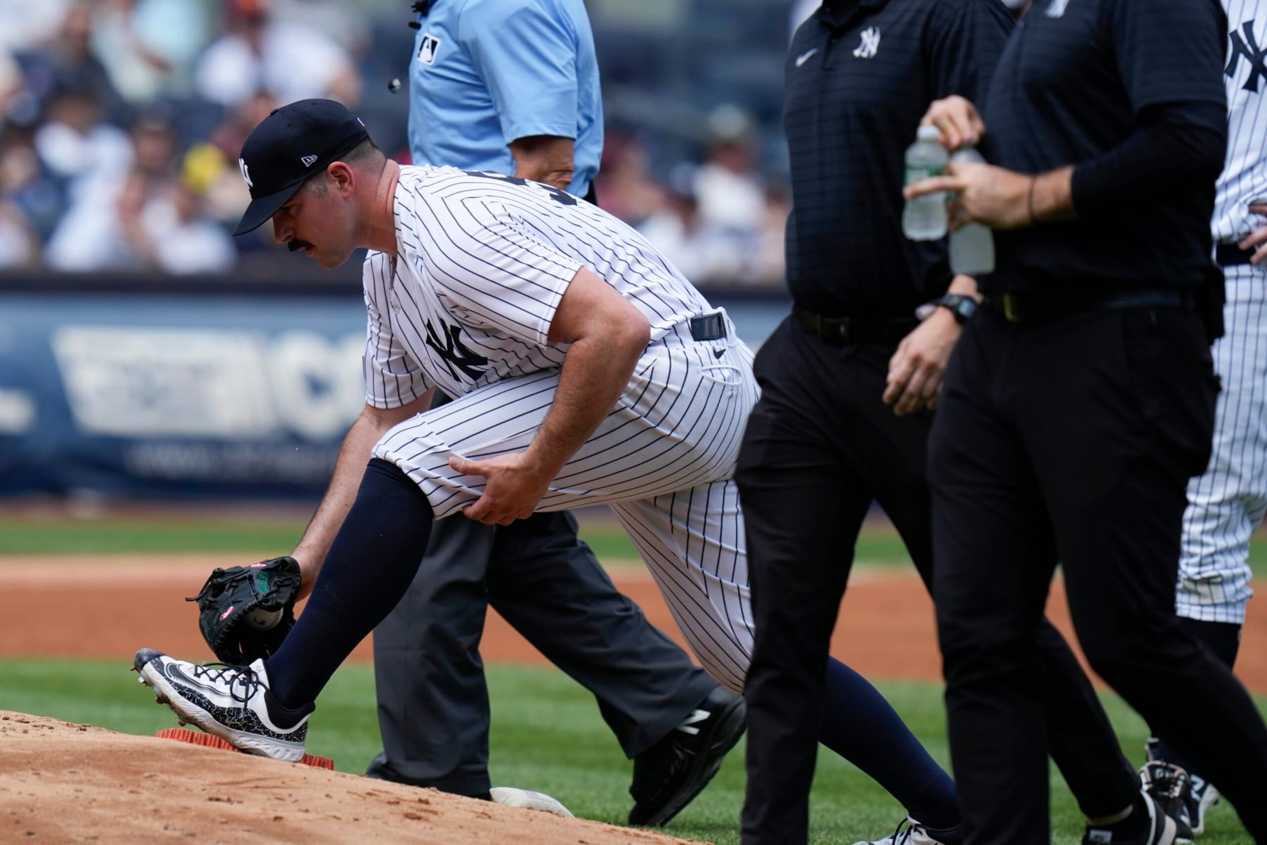 New York Yankees' Carlos Rodon, front left, stretches before being pulled during the third inning of a baseball game against the Houston Astros at Yankee Stadium, Sunday, Aug. 6, 2023, in New York. (AP Photo/Seth Wenig)