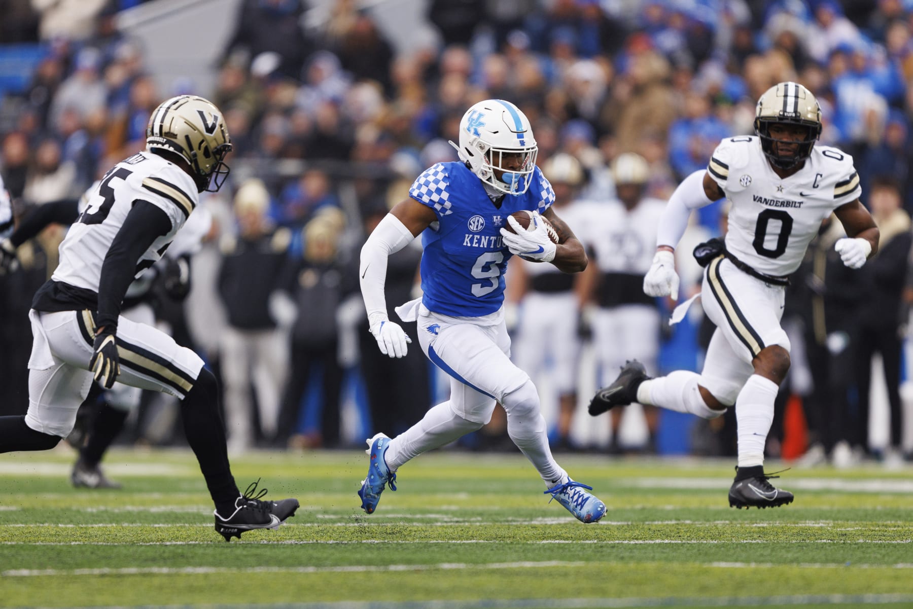 Kentucky wide receiver Tayvion Robinson (9) runs the ball down the field while be chased by Vanderbilt cornerback Jeremy Lucien (25) and linebacker Anfernee Orji (0) during an NCAA college football game in Lexington, Ky., Saturday, Nov. 12, 2022. (AP Photo/Michael Clubb)