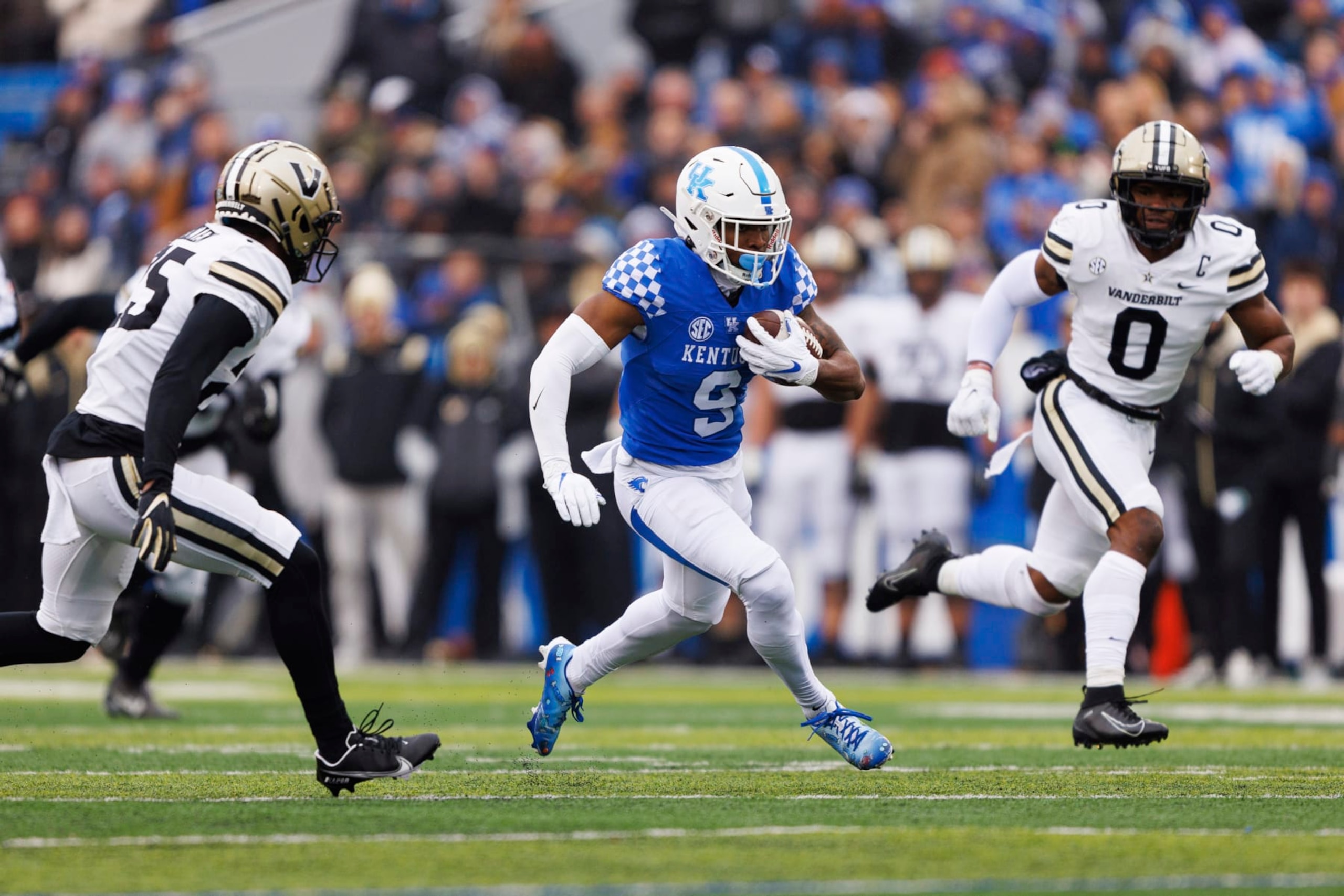 Kentucky wide receiver Tayvion Robinson (9) runs the ball down the field while be chased by Vanderbilt cornerback Jeremy Lucien (25) and linebacker Anfernee Orji (0) during an NCAA college football game in Lexington, Ky., Saturday, Nov. 12, 2022. (AP Photo/Michael Clubb)