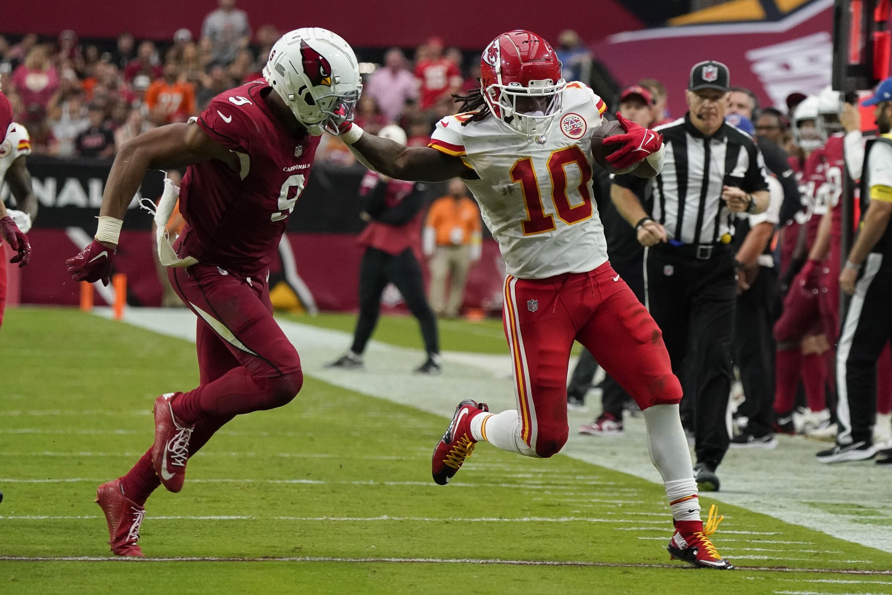 Kansas City Chiefs reciever Isiah Pacheco (10) gives a stiff arm to Arizona Cardinals Isaiah Simmons (9) during the second half of an NFL football game Sunday, Sept. 11, 2022, in Glendale, Ariz. (AP Photo/Darryl Webb)