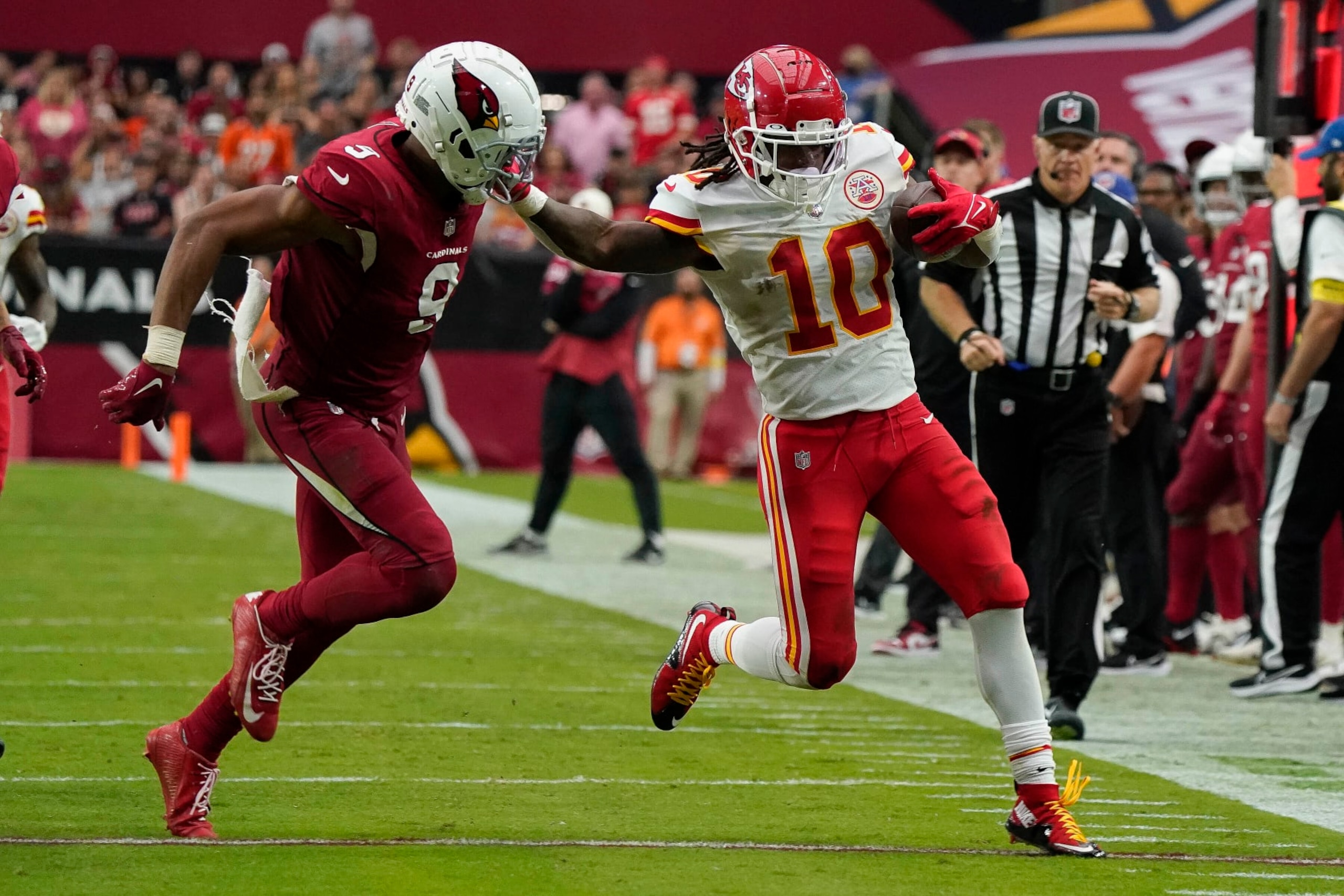 Kansas City Chiefs reciever Isiah Pacheco (10) gives a stiff arm to Arizona Cardinals Isaiah Simmons (9) during the second half of an NFL football game Sunday, Sept. 11, 2022, in Glendale, Ariz. (AP Photo/Darryl Webb)