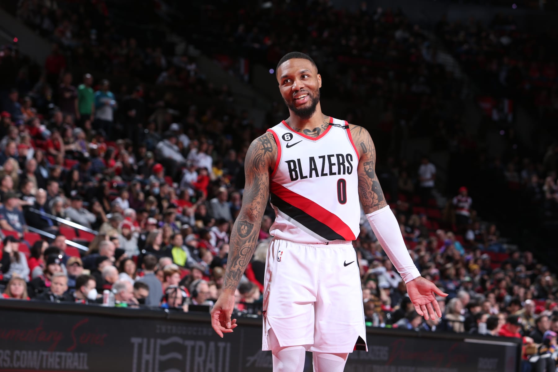 PORTLAND, OR - JANUARY 28: Damian Lillard #0 of the Portland Trail Blazers smiles during the game against the Toronto Raptors  January 28, 2023 at the Moda Center Arena in Portland, Oregon. NOTE TO USER: User expressly acknowledges and agrees that, by downloading and or using this photograph, user is consenting to the terms and conditions of the Getty Images License Agreement. Mandatory Copyright Notice: Copyright 2023 NBAE (Photo by Sam Forencich/NBAE via Getty Images)