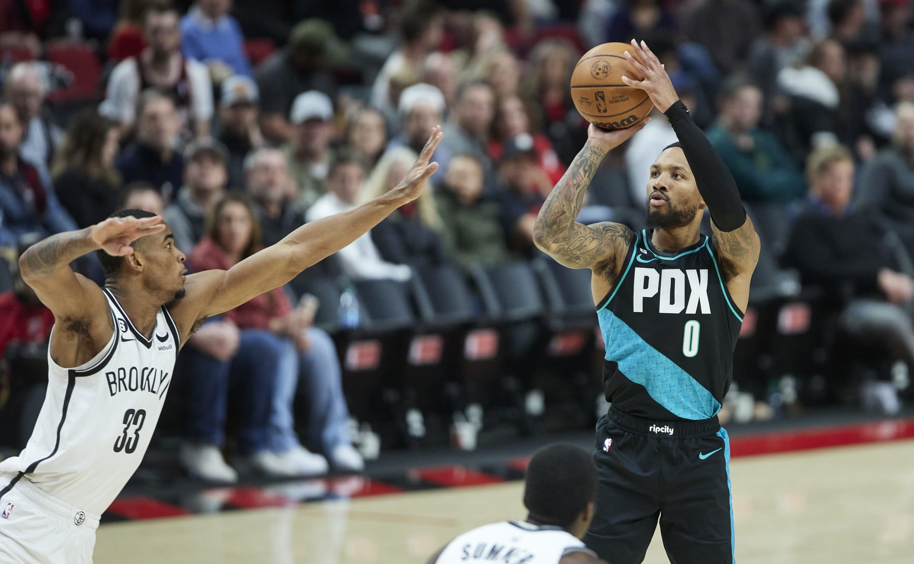Portland Trail Blazers guard Damian Lillard, right, shoots over Brooklyn Nets forward Nic Claxton, left, during the second half of an NBA basketball game in Portland, Ore., Thursday, Nov. 17, 2022. (AP Photo/Craig Mitchelldyer)