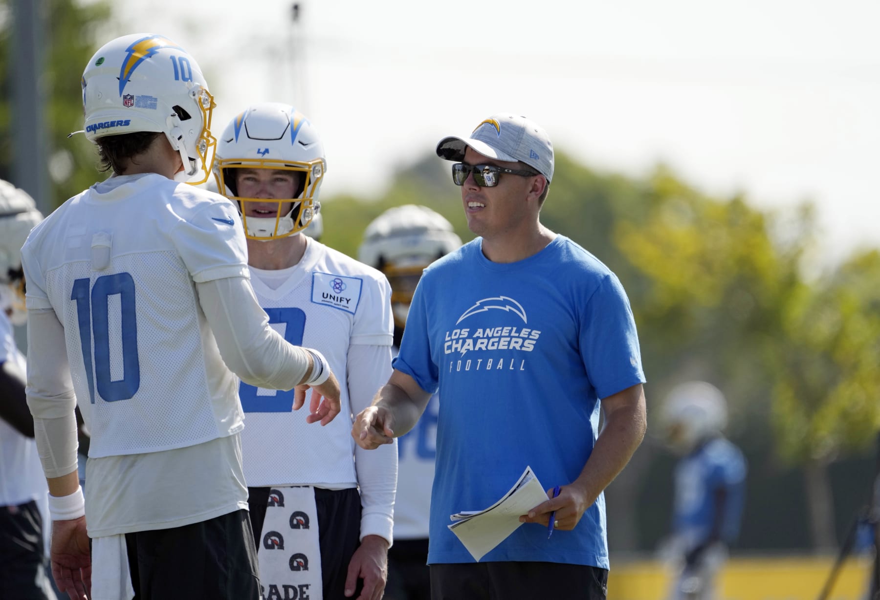 COSTA MESA, CALIFORNIA - AUGUST 5: Offensive coordinator Kellen Moore of the Los Angeles Chargers talks with quarterback Justin Herbert #10 during training camp at Jack Hammett Sports Complex on August 5, 2023 in Costa Mesa, California. (Photo by Kevork Djansezian/Getty Images)
