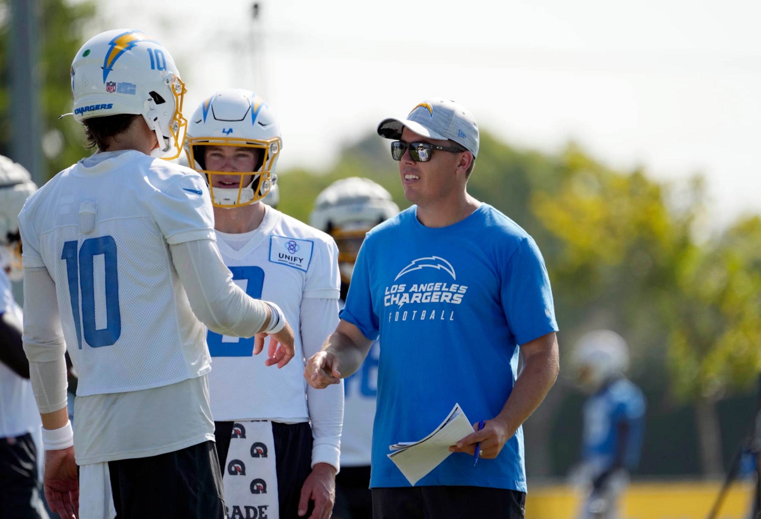 COSTA MESA, CALIFORNIA - AUGUST 5: Offensive coordinator Kellen Moore of the Los Angeles Chargers talks with quarterback Justin Herbert #10 during training camp at Jack Hammett Sports Complex on August 5, 2023 in Costa Mesa, California. (Photo by Kevork Djansezian/Getty Images)