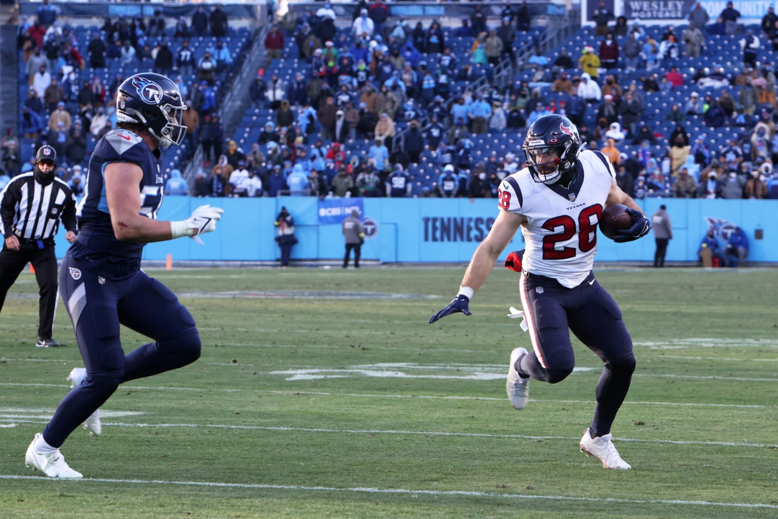 NASHVILLE, TN - DECEMBER 24: Houston Texans running back Rex Burkhead (28) runs the ball in front of Tennessee Titans linebacker Dylan Cole (53) during a game between the Tennessee Titans and the Houston Texans, December 24, 2022 at Nissan  Stadium in Nashville, Tennessee. (Photo by Matthew Maxey/Icon Sportswire via Getty Images)