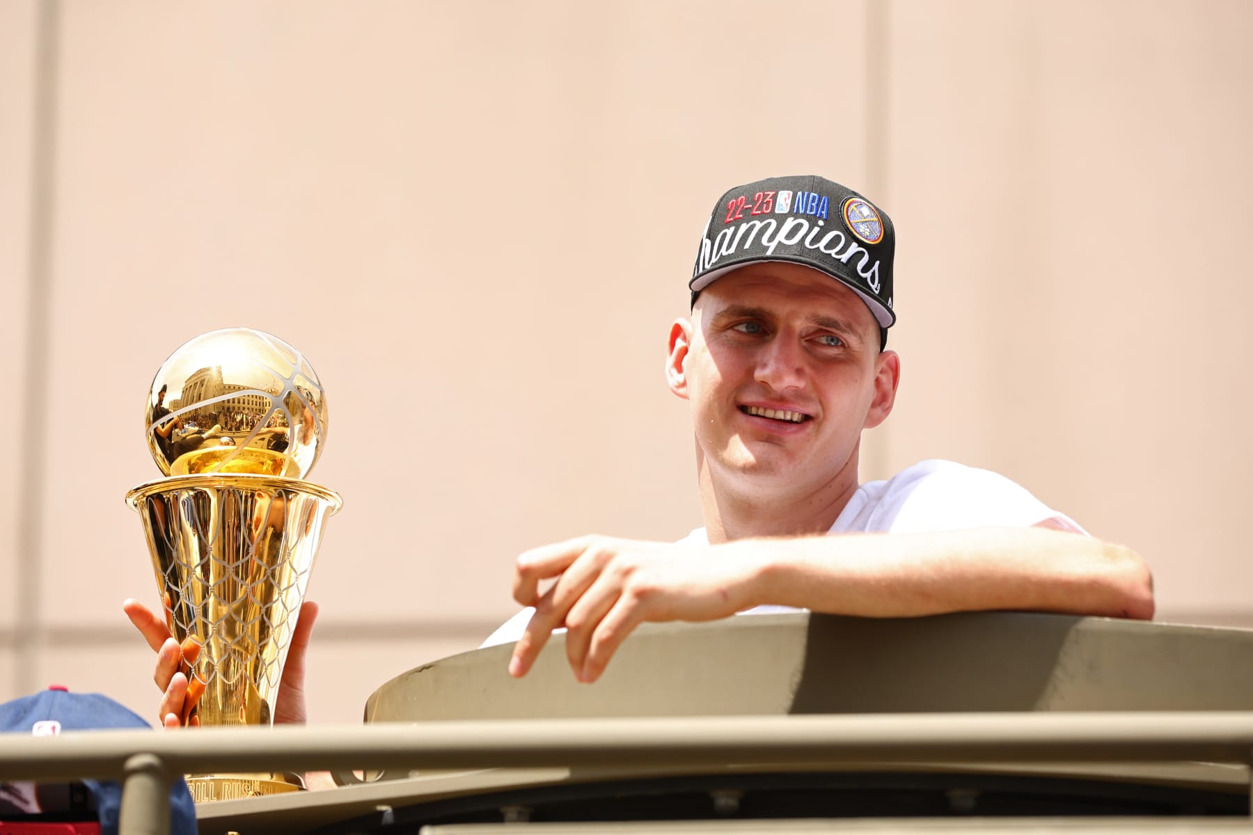 DENVER, CO - JUNE 15: Nikola Jokic #15 of the Denver Nuggets celebrates with the Bill Russell Finals MVP Trophy during the 2023 Denver Nuggets Championship Parade on June 15, 2023 in Denver, Colorado. NOTE TO USER: User expressly acknowledges and agrees that, by downloading and/or using this Photograph, user is consenting to the terms and conditions of the Getty Images License Agreement. Mandatory Copyright Notice: Copyright 2023 NBAE (Photo by Jamie Schwaberow/NBAE via Getty Images)