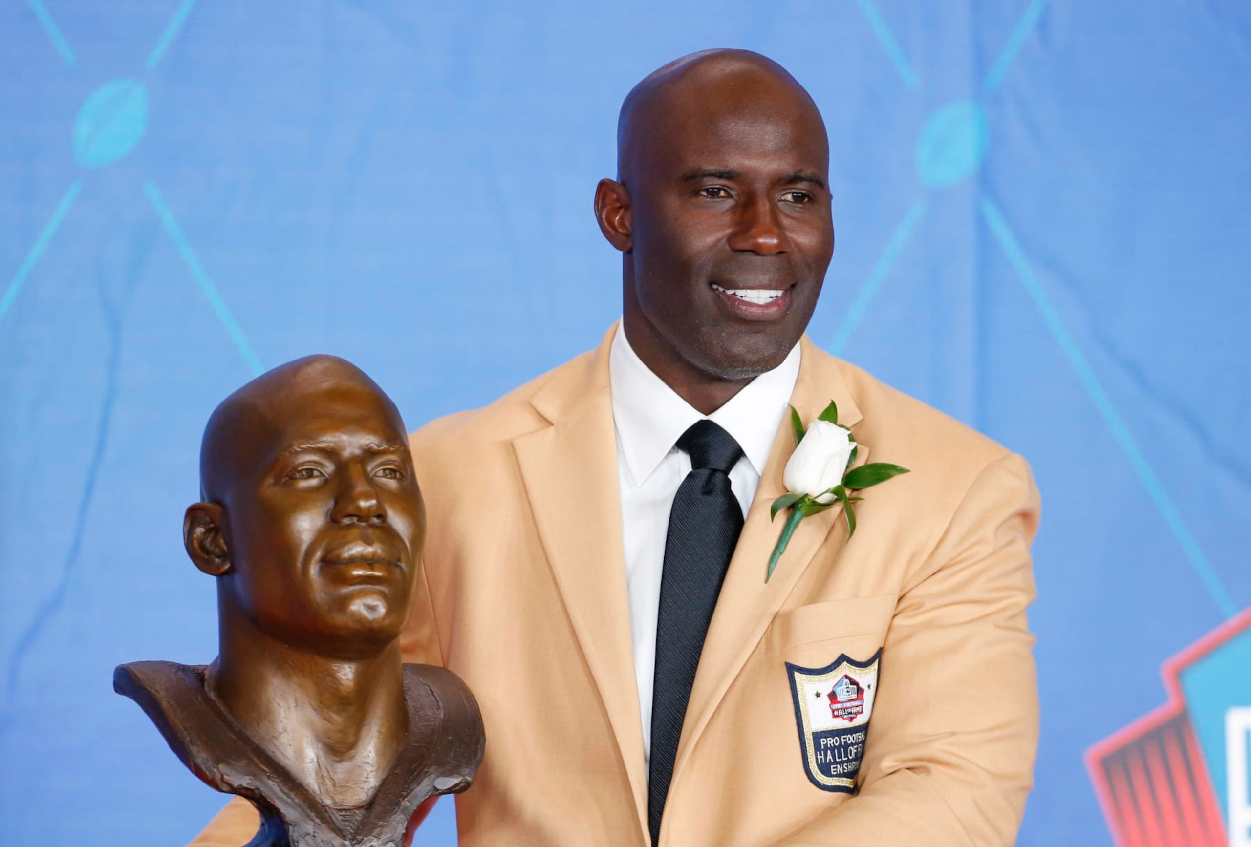 Former NFL player Terrell Davis poses with a bust of himself during an induction ceremony at the Pro Football Hall of Fame Saturday, Aug. 5, 2017, in Canton, Ohio. (AP Photo/Ron Schwane)