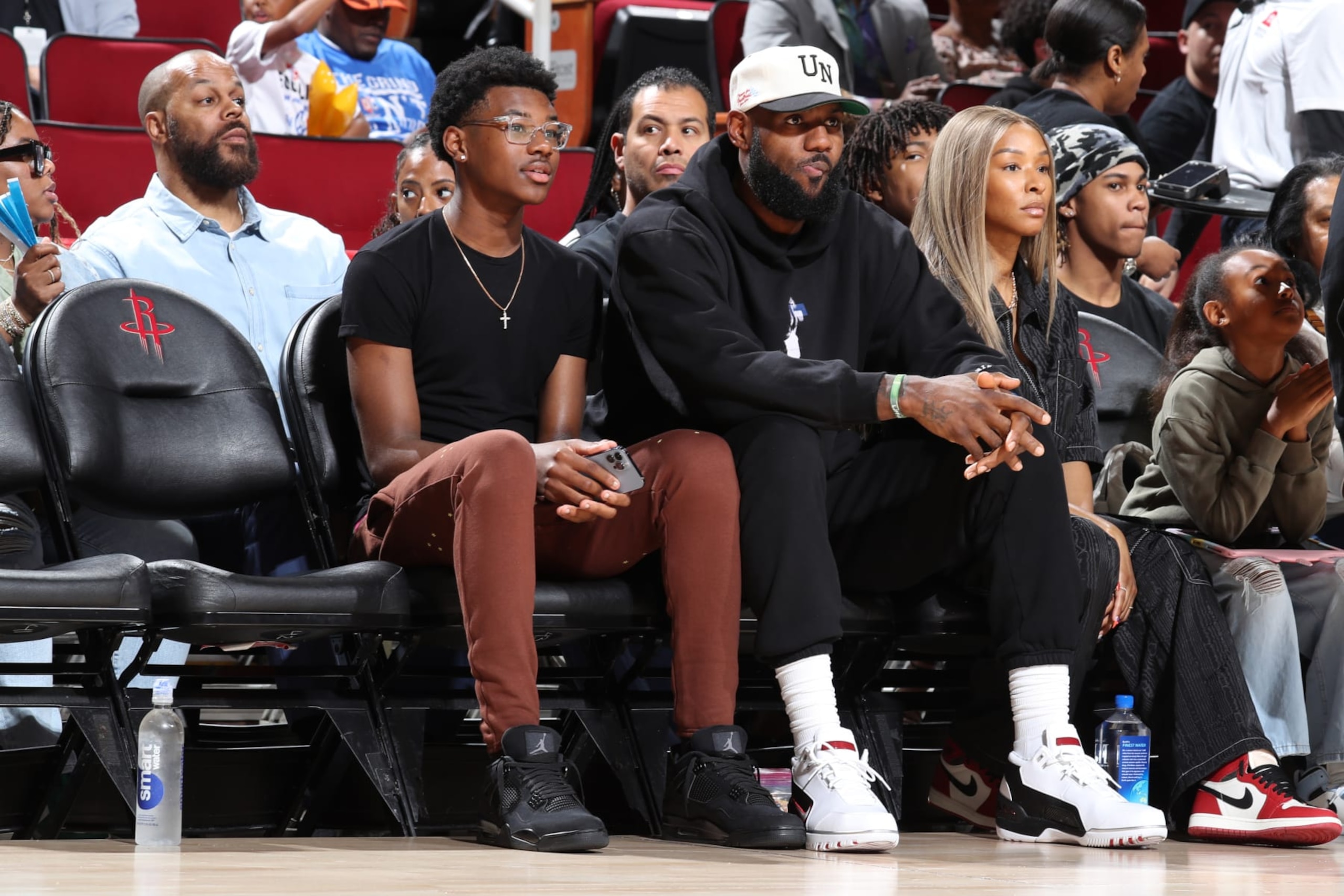 HOUSTON, TX - MARCH 28: From left to right Bryce James and LeBron James and Savannah James are sitting in the front row to watch McDonalds High School All American Bronny James play during the 2023 McDonalds High School All American Boys Game at Toyota Center. (Photo by Brian Spurlock/Icon Sportswire via Getty Images HOUSTON, TX - MARCH 28: From left to right Bryce James and LeBron James and Savannah James are sitting in the front row to watch McDonalds High School All American Bronny James play during the 2023 McDonalds High School All American Boys Game at Toyota Center. (Photo by Brian Spurlock/Icon Sportswire via Getty Images