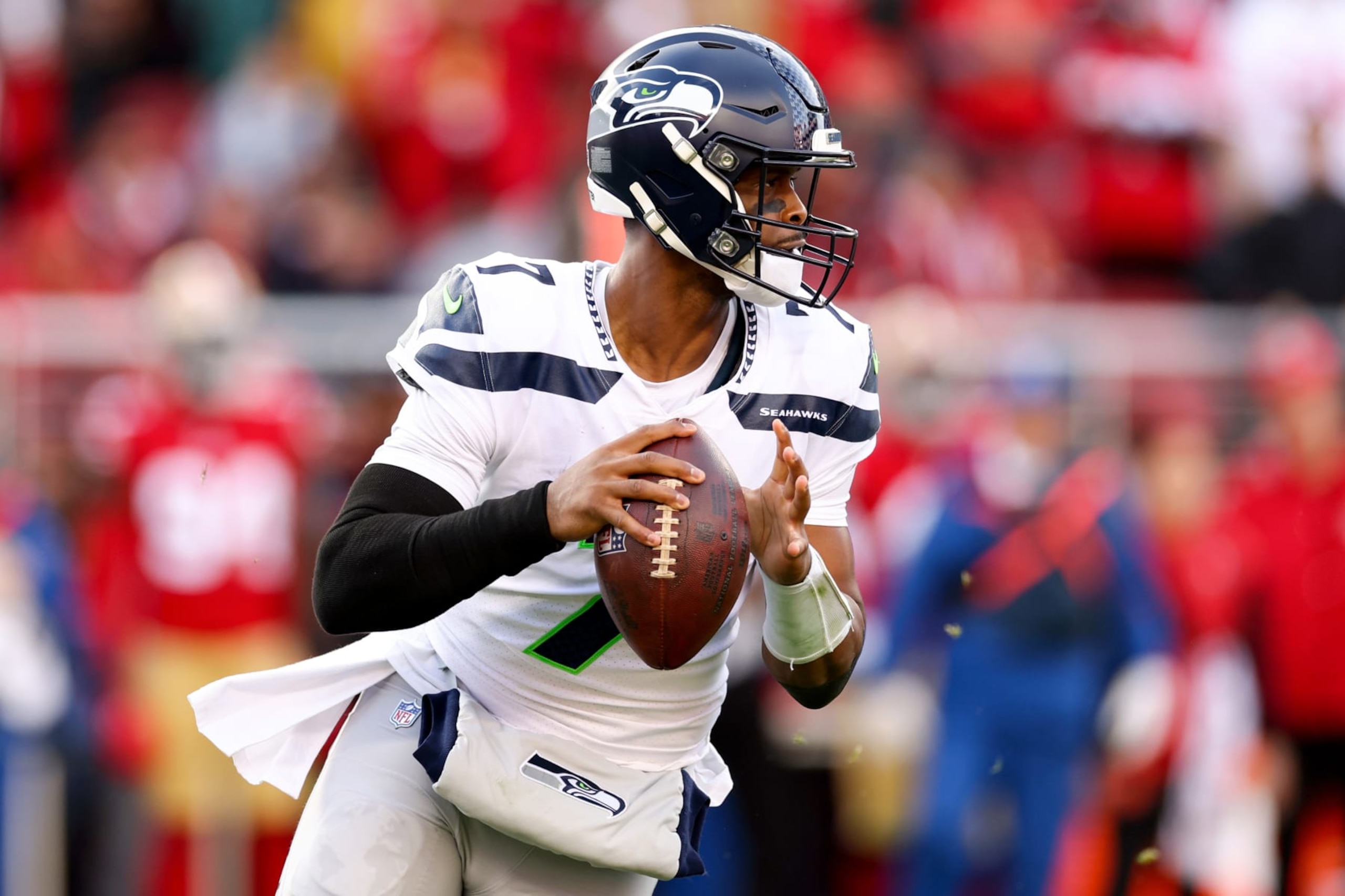 SANTA CLARA, CALIFORNIA - JANUARY 14: Geno Smith #7 of the Seattle Seahawks looks to pass against the San Francisco 49ers during the first half of the game in the NFC Wild Card playoff game at Levi's Stadium on January 14, 2023 in Santa Clara, California. (Photo by Ezra Shaw/Getty Images)