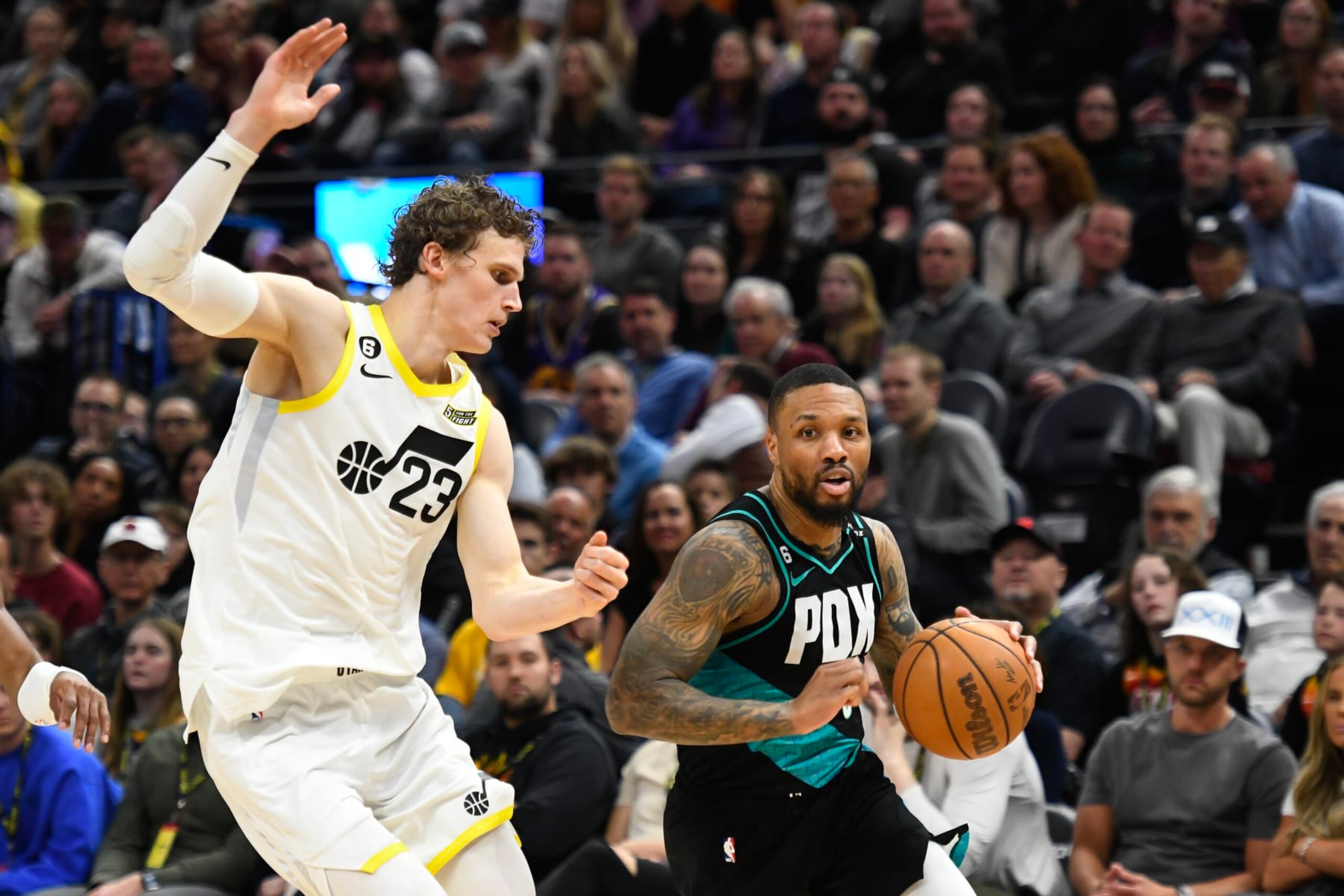 SALT LAKE CITY, UTAH - MARCH 22: Damian Lillard #0 of the Portland Trail Blazers drives against Lauri Markkanen #23 of the Utah Jazz during the second half at Vivint Arena on March 22, 2023 in Salt Lake City, Utah. NOTE TO USER: User expressly acknowledges and agrees that, by downloading and or using this photograph, User is consenting to the terms and conditions of the Getty Images License Agreement. (Photo by Alex Goodlett/Getty Images)