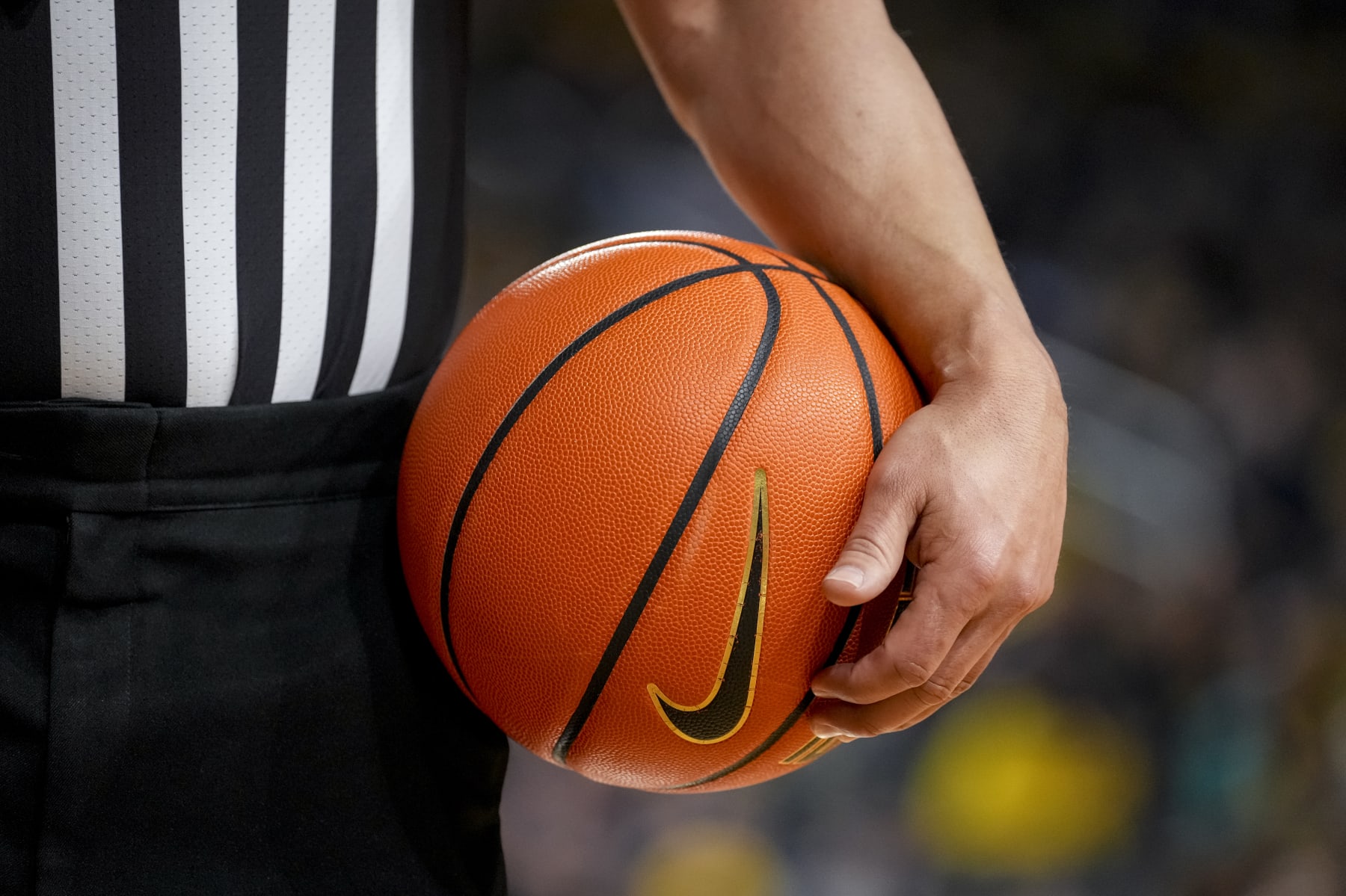 ANN ARBOR, MICHIGAN - FEBRUARY 26: A referee holds a Nike brand basketball during the game between the Wisconsin Badgers and Michigan Wolverines at Crisler Arena on February 26, 2023 in Ann Arbor, Michigan. (Photo by Nic Antaya/Getty Images)