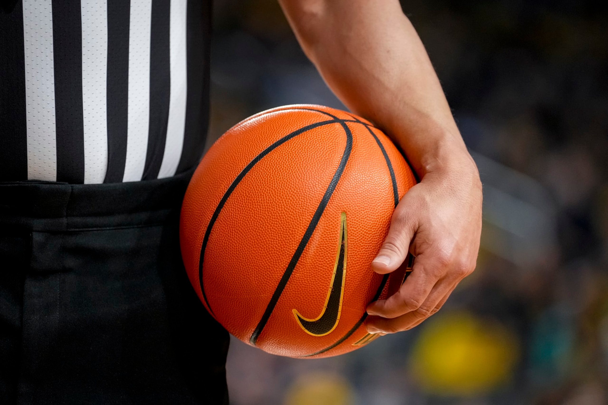 ANN ARBOR, MICHIGAN - FEBRUARY 26: A referee holds a Nike brand basketball during the game between the Wisconsin Badgers and Michigan Wolverines at Crisler Arena on February 26, 2023 in Ann Arbor, Michigan. (Photo by Nic Antaya/Getty Images) ANN ARBOR, MICHIGAN - FEBRUARY 26: A referee holds a Nike brand basketball during the game between the Wisconsin Badgers and Michigan Wolverines at Crisler Arena on February 26, 2023 in Ann Arbor, Michigan. (Photo by Nic Antaya/Getty Images)