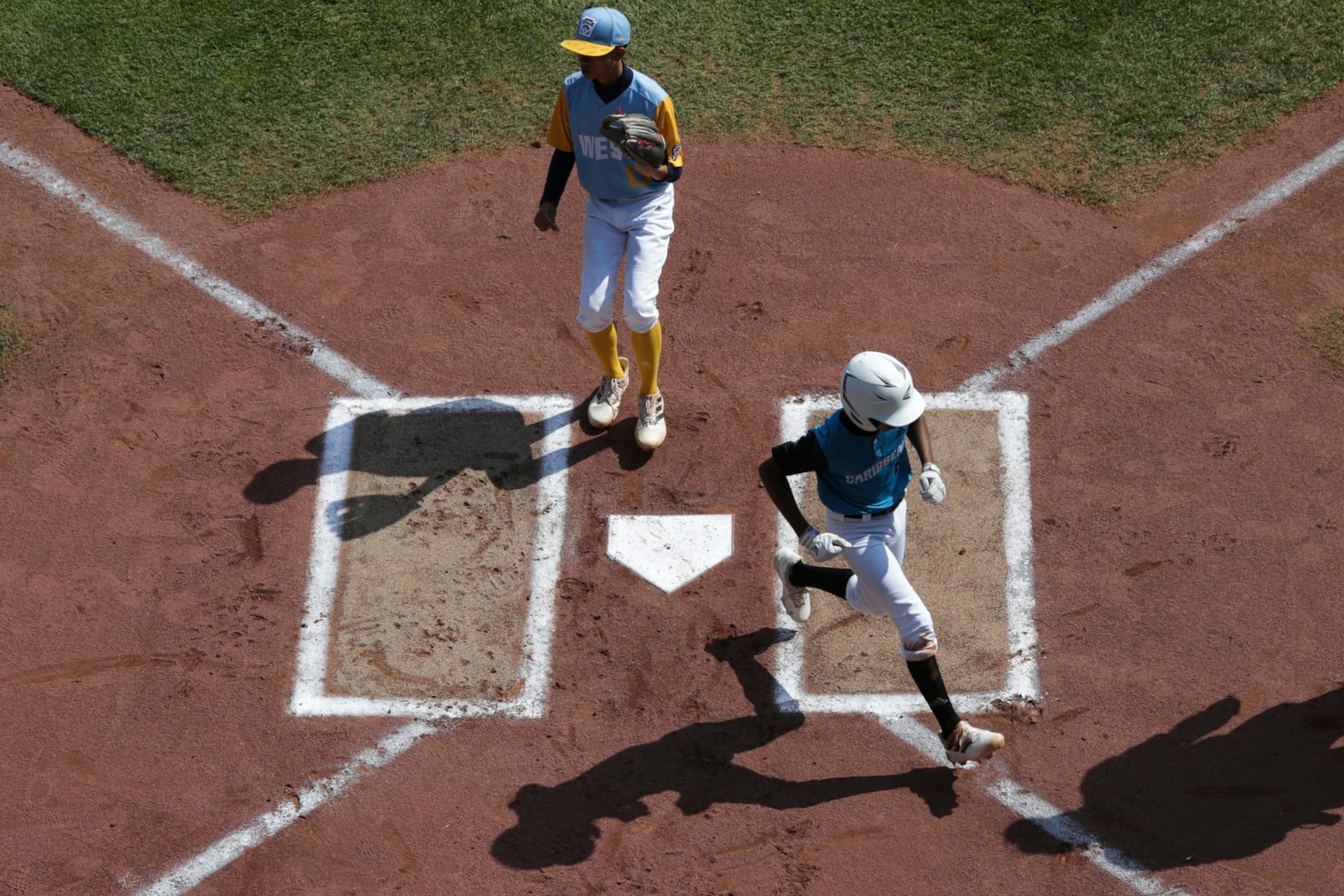 SOUTH WILLIAMSPORT, PENNSYLVANIA - AUGUST 28: Davey-Jay Rijke #8 of the Caribbean Region team from Willemstad, Curacao scores during the first inning of the Little League World Series Championship game against the West Region team from Honolulu, Hawaii at the Little League International Complex on August 28, 2022 in South Williamsport, Pennsylvania. (Photo by Joshua Bessex/Getty Images)