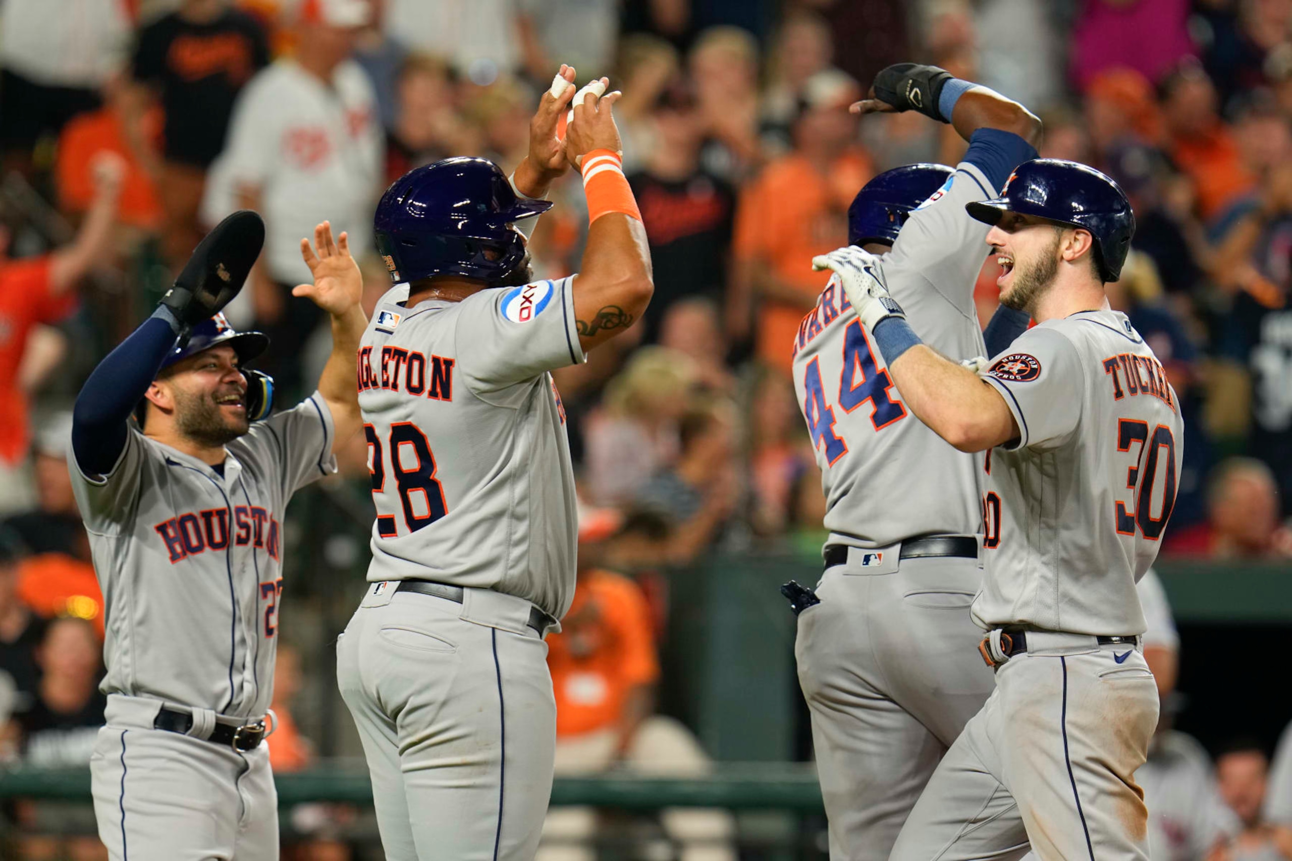 Houston Astros' Kyle Tucker, right, celebrates his ninth inning grand slam with Jose Altuve, left, Jon Singleton, second from left, and Yordan Alvarez (44) during a baseball game against the Baltimore Orioles, Tuesday, Aug. 8, 2023, in Baltimore. The Astros won 7-6. (AP Photo/Julio Cortez)
