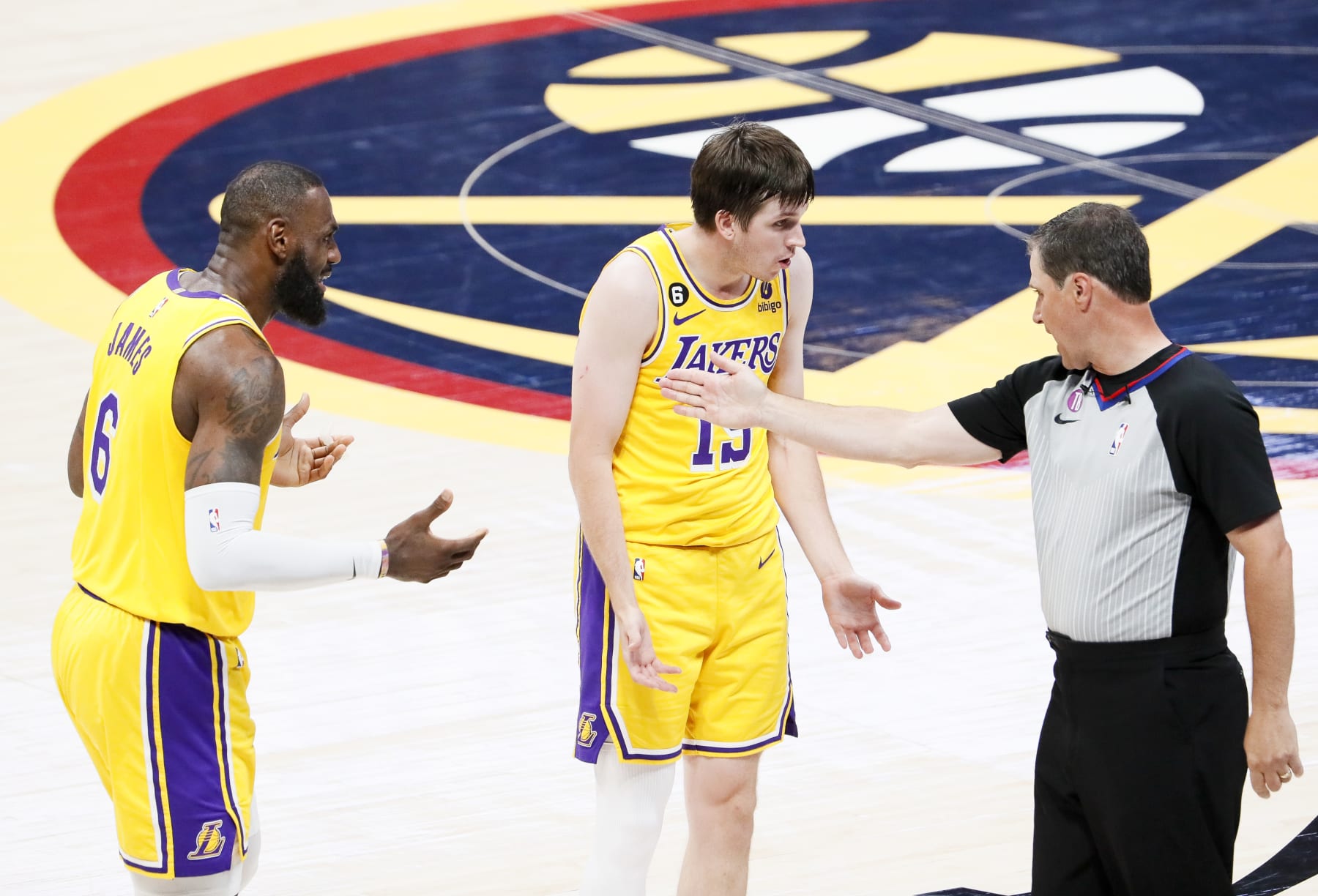 DENVER, CO - MAY 18: Los Angeles Lakers forward LeBron James, from left, and guard Austin Reaves talk with NBA referee David Guthrie during the second half of game two in the NBA Playoffs Western Conference Finals against the Denver Nuggets at Ball Arena on Thursday, May 18, 2023 in Denver, CO. (Robert Gauthier / Los Angeles Times via Getty Images)