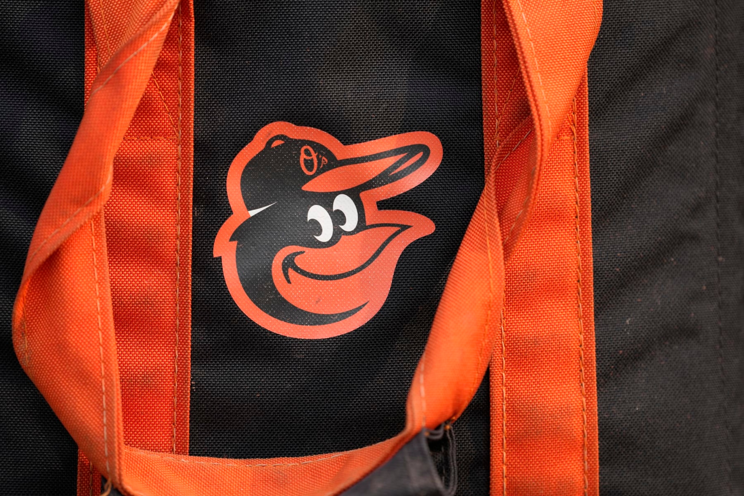BALTIMORE, MD - JULY 17:  The Baltimore Orioles logo on a baseball bag on the field before a baseball game against the Los Angeles Dodgers at Oriole Park at Camden Yards on July 17, 2023 in Baltimore, Maryland.  (Photo by Mitchell Layton/Getty Images)