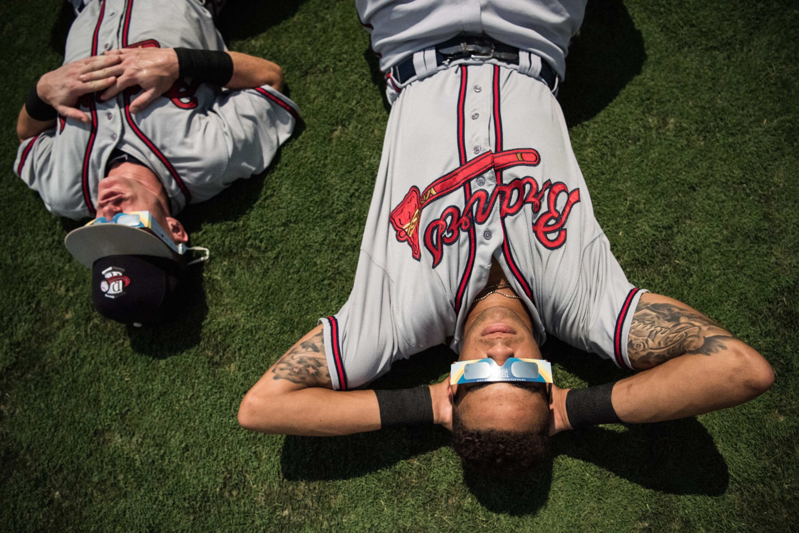 COLUMBIA, SC - AUGUST 21: Members of the Rome Braves watch the eclipse at Spirit Communications Park during a break in  minor league baseball August 21, 2017 in Columbia, South Carolina. The astrological occurrence marks the first transcontinental total solar eclipse in 99 years. (Photo by Sean Rayford/Getty Images)