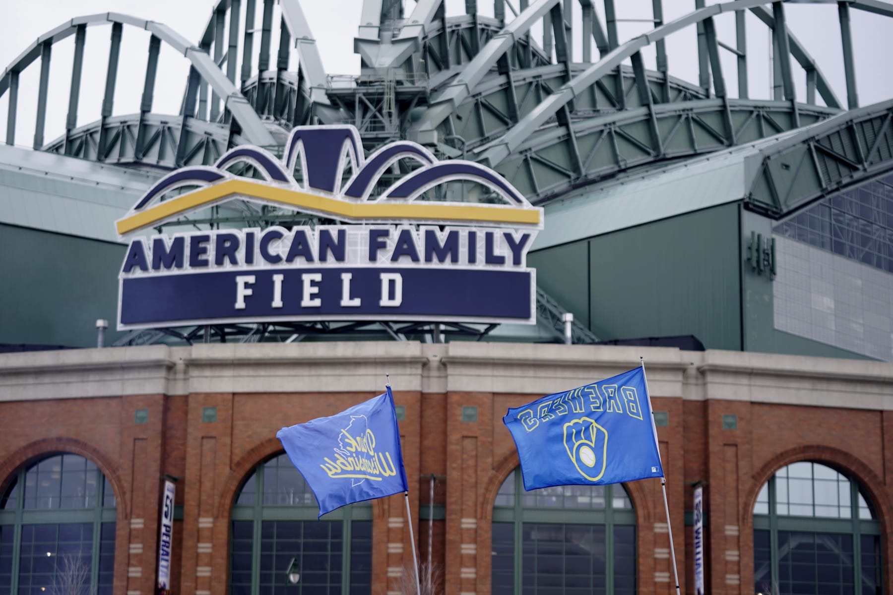 Flags fly in front of American Family Field before a baseball game between the Milwaukee Brewers and the New York Mets Monday, April 3, 2023, in Milwaukee. (AP Photo/Aaron Gash)