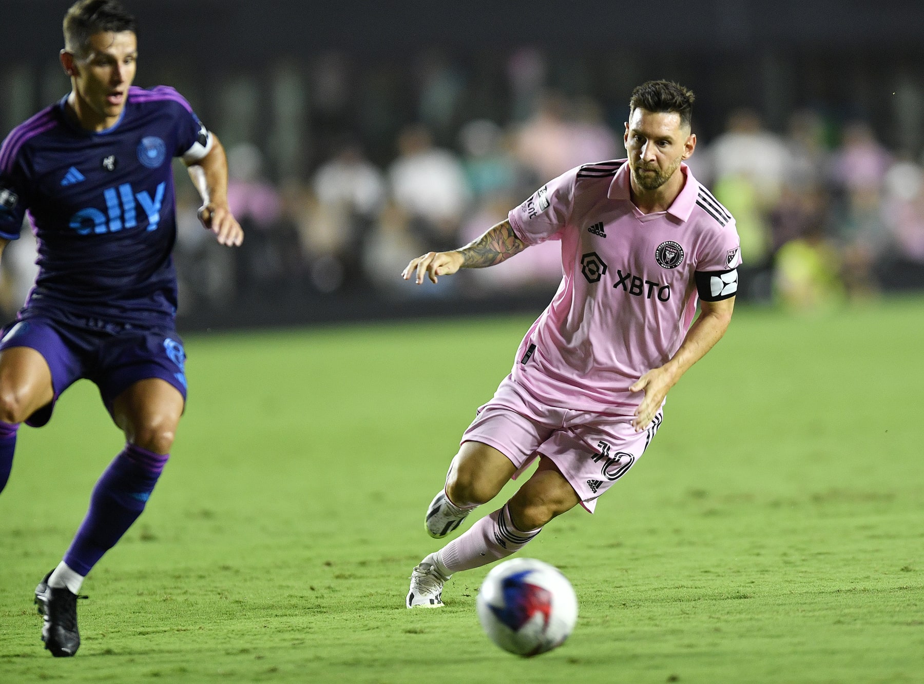 Inter Miami forward Lionel Messi, right, dribbles the ball in front of Charlotte FC midfielder Ashley Westwood during the first half of a Leagues Cup soccer match Friday, Aug. 11, 2023, in Fort Lauderdale, Fla. (AP Photo/Michael Laughlin)