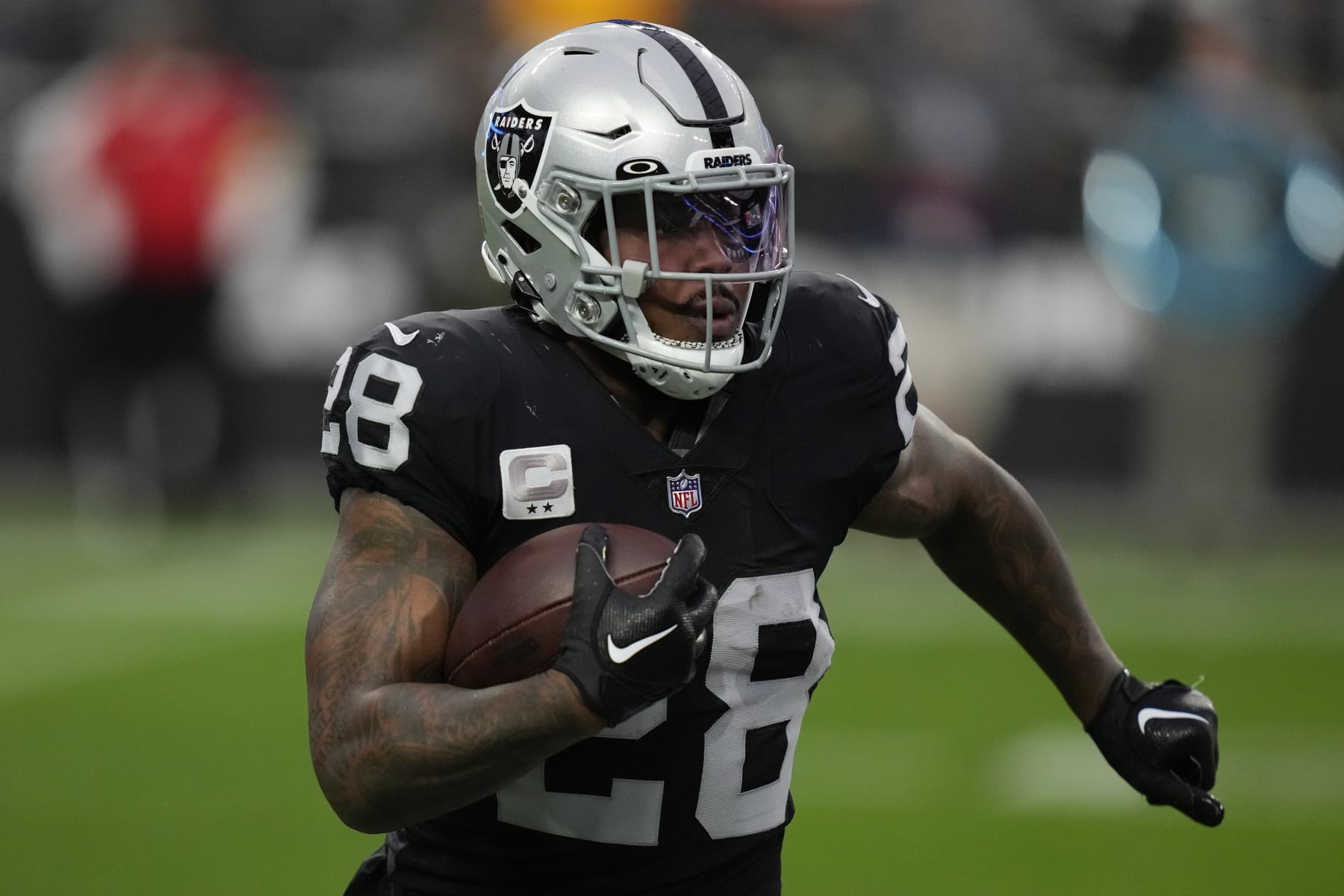 Las Vegas Raiders running back Josh Jacobs (28) runs against the Kansas City Chiefs during the first half of an NFL football game, Wednesday, Jan. 11, 2023, in Las Vegas. (AP Photo/John Locher)