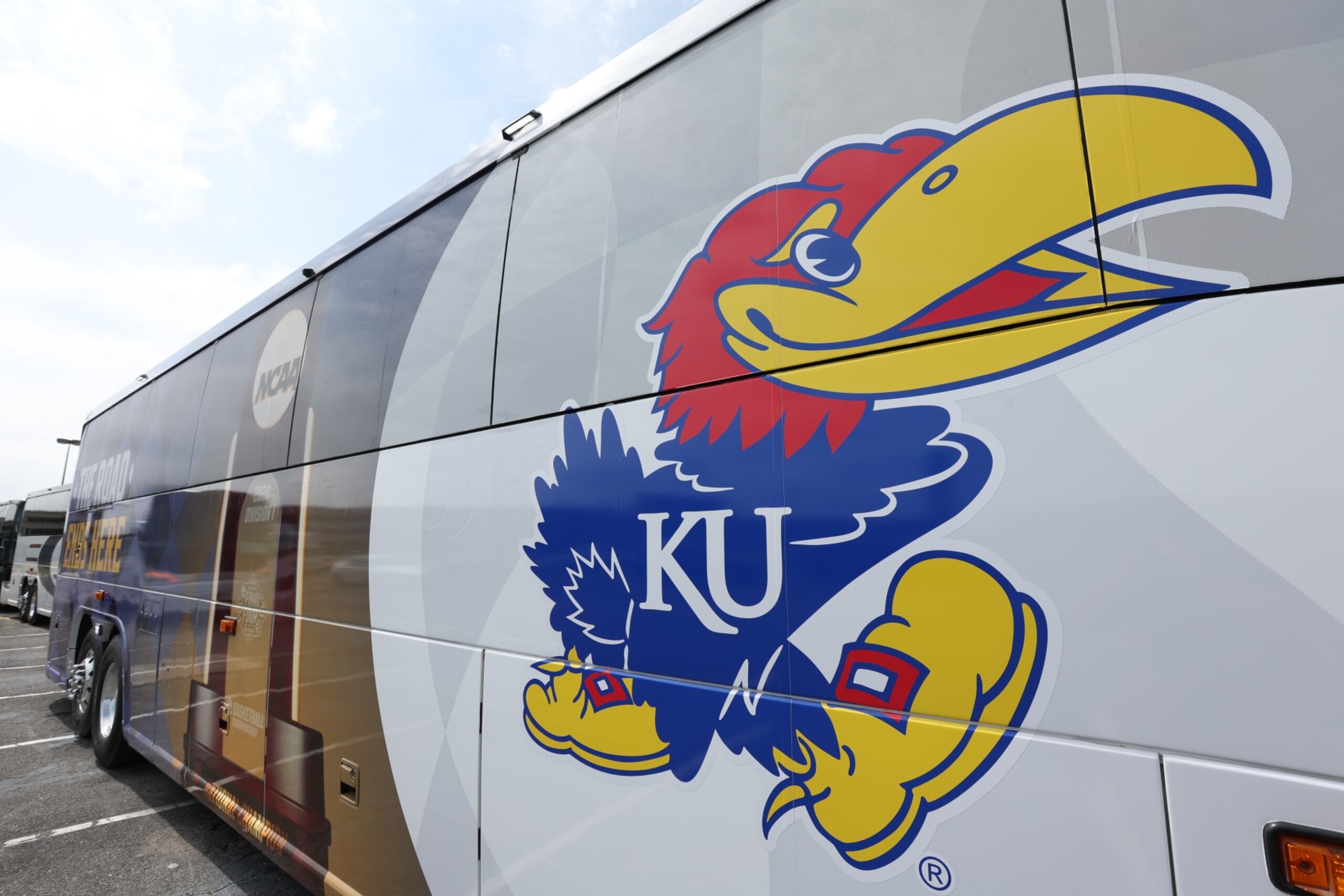 NEW ORLEANS, LA - MARCH 30: A bus decorated with the Kansas Jayhawks and Final Four logos sits at the Louis Armstrong New Orleans International Airport on March 30, 2022 in New Orleans, Louisiana. (Photo by Isaiah Vazquez/NCAA Photos via Getty Images) NEW ORLEANS, LA - MARCH 30: A bus decorated with the Kansas Jayhawks and Final Four logos sits at the Louis Armstrong New Orleans International Airport on March 30, 2022 in New Orleans, Louisiana. (Photo by Isaiah Vazquez/NCAA Photos via Getty Images)