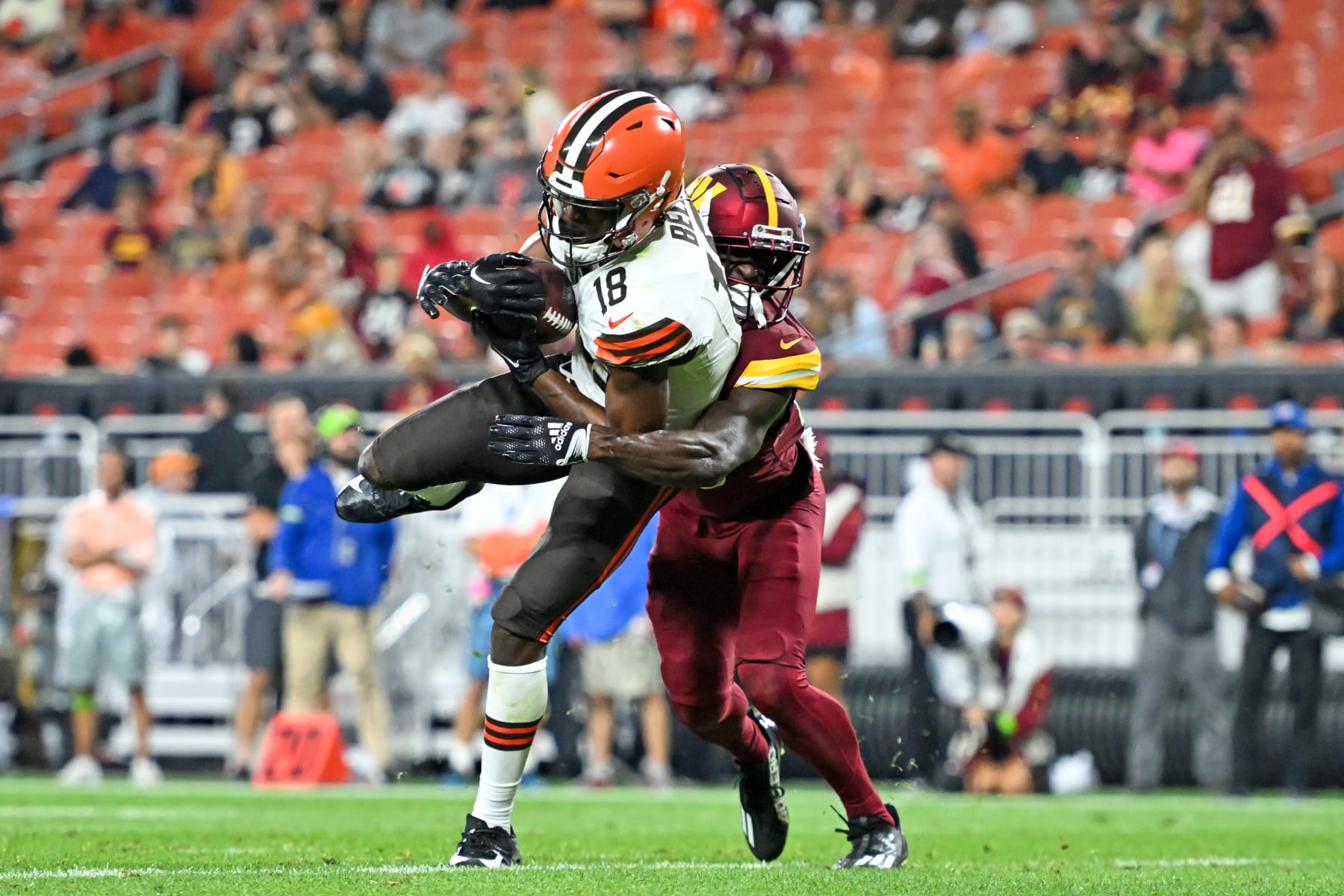 CLEVELAND, OHIO - AUGUST 11: David Bell #18 of the Cleveland Browns catches a seven-yard touchdown against Jartavius Martin #20 of the Washington Commanders during the second half of a preseason game at Cleveland Browns Stadium on August 11, 2023 in Cleveland, Ohio. (Photo by Nick Cammett/Getty Images)