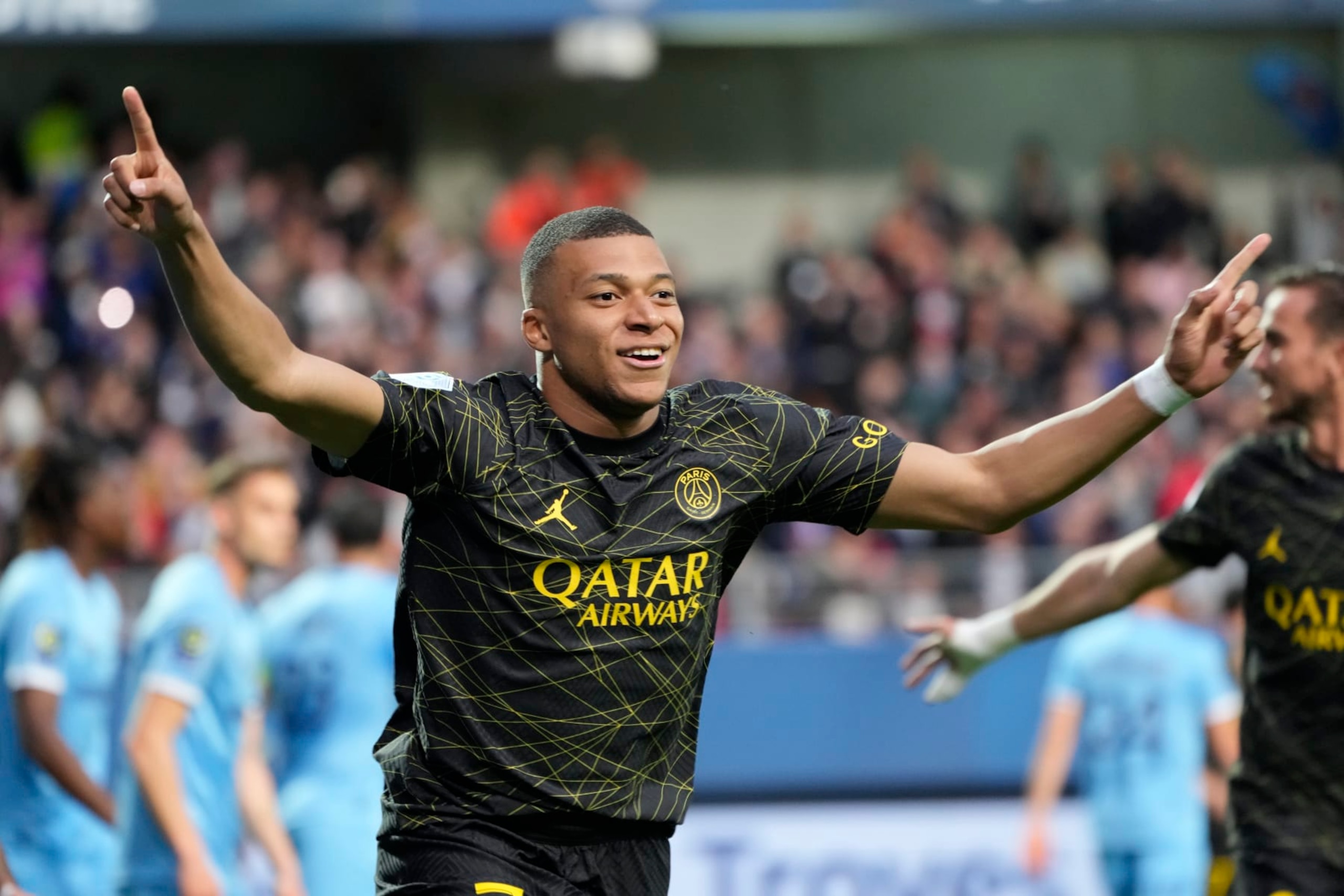 PSG's Kylian Mbappe celebrates after scoring his side's opening goal during the French League One soccer match between Troyes and Paris Saint Germain, at the Stade de l'Aube, in Troyes, France, Sunday, May 7, 2023. (AP Photo/Lewis Joly)